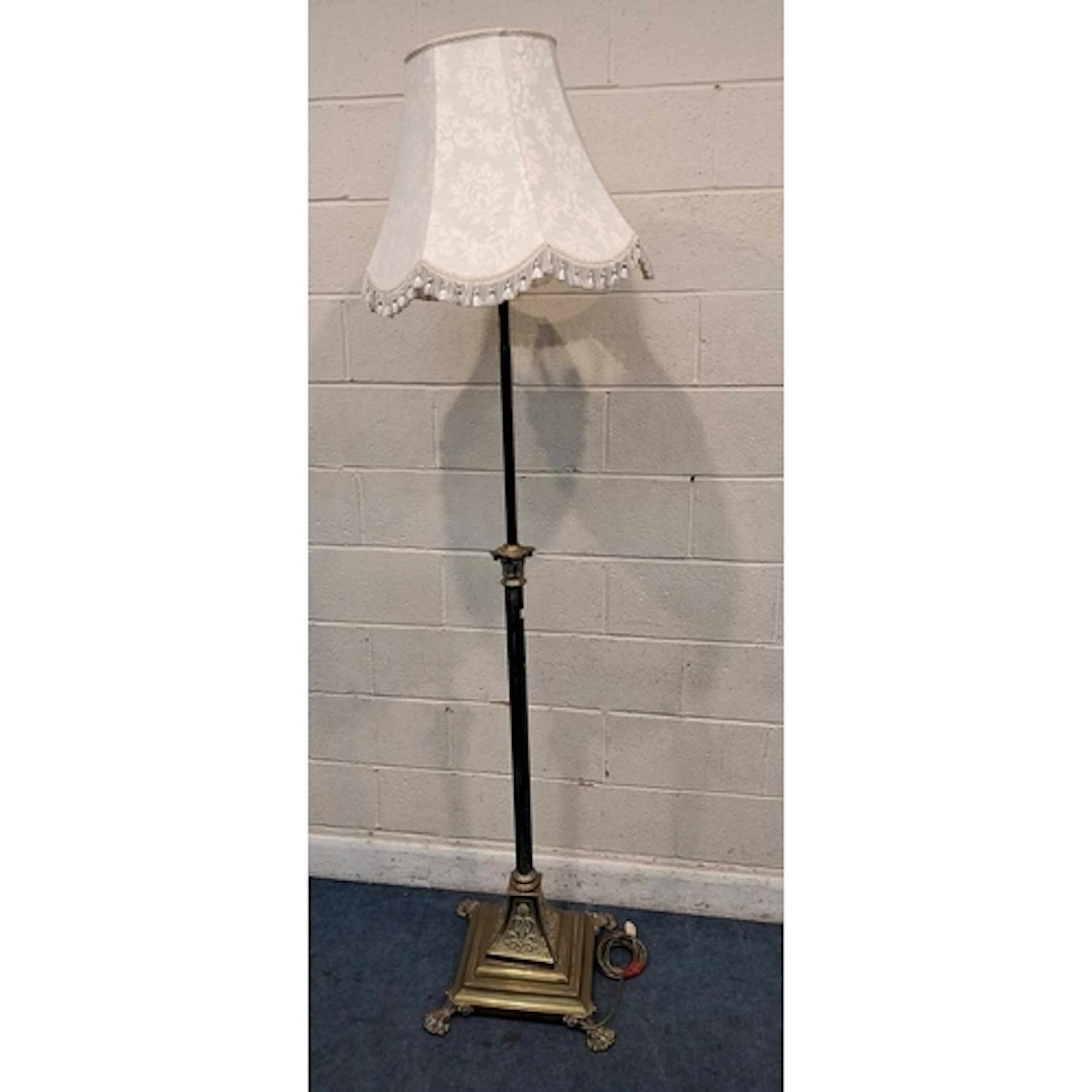 A BRASS TELESCOPIC STANDARD LAMP, with a Corinthian style pi...
