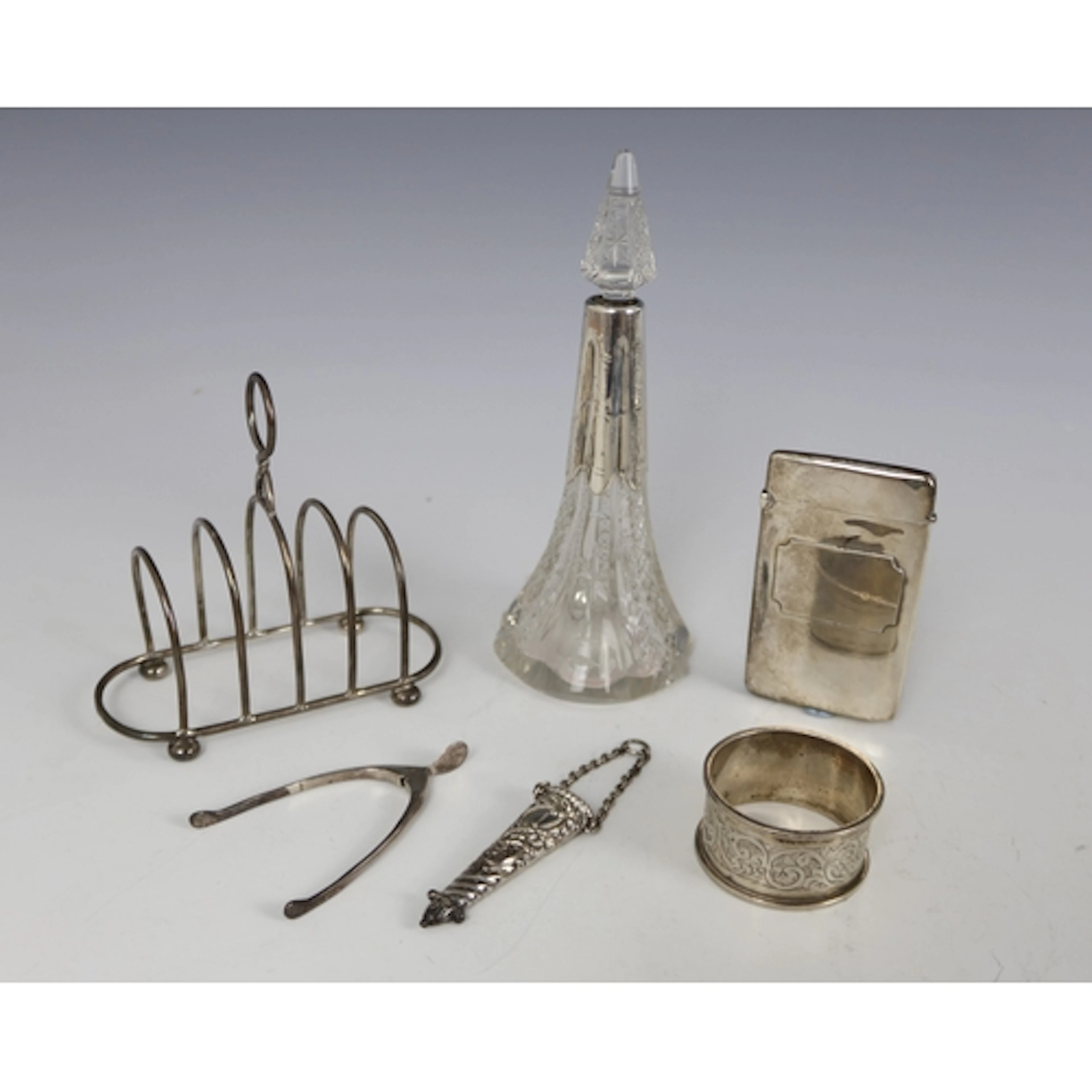 A silver card case, Chester 1911, a silver toast rack, Chest...