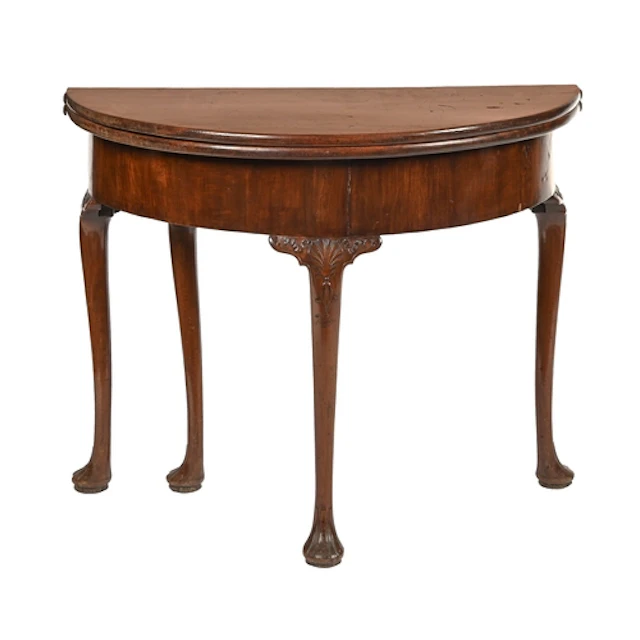 A George II mahogany tea table, with two fold over semi-circ...