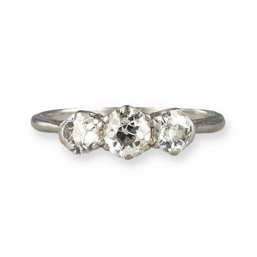 A PLATINUM THREE STONE DIAMOND RING Weight: 2.9gms Band mark...