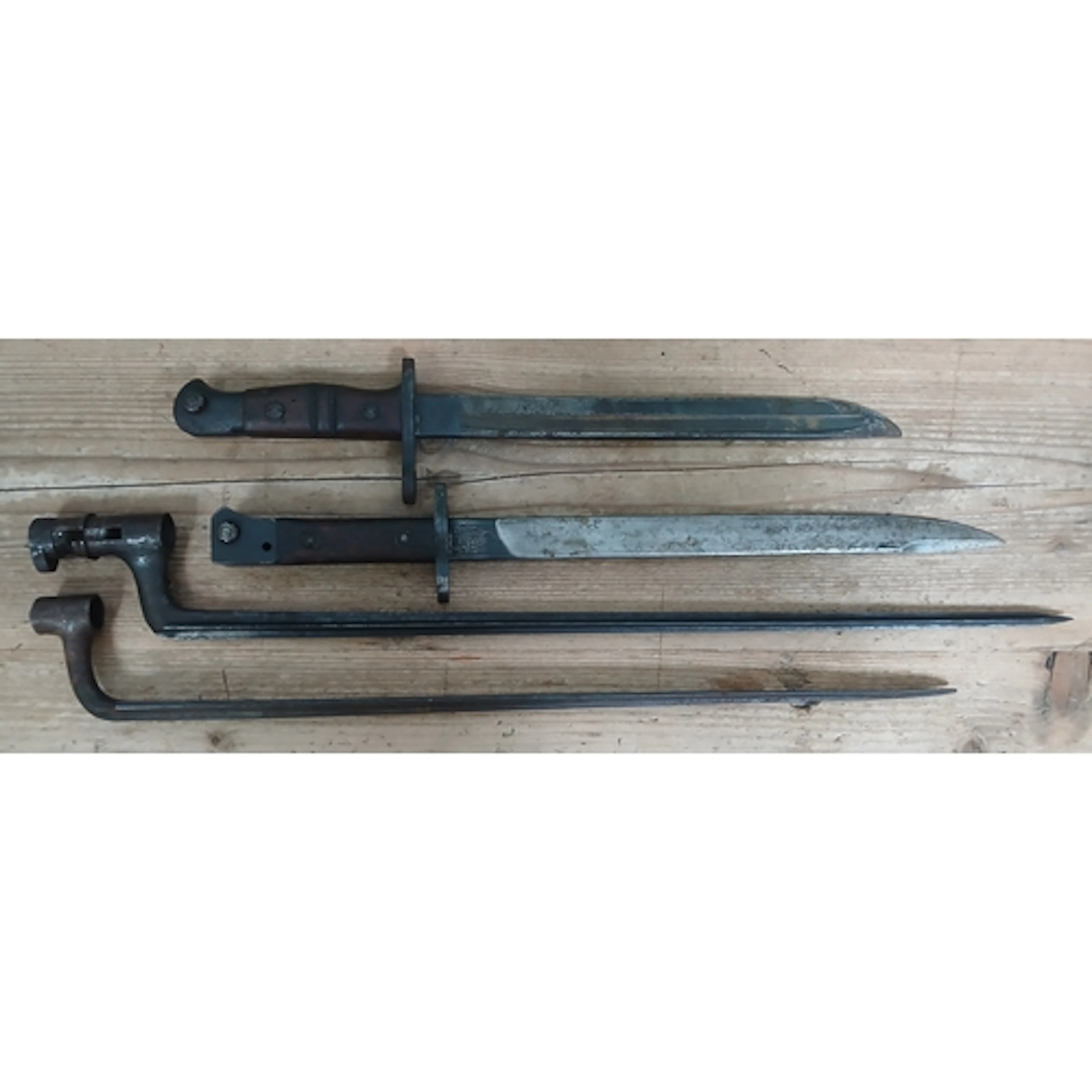 A group of four assorted bayonets lacking scabbards.