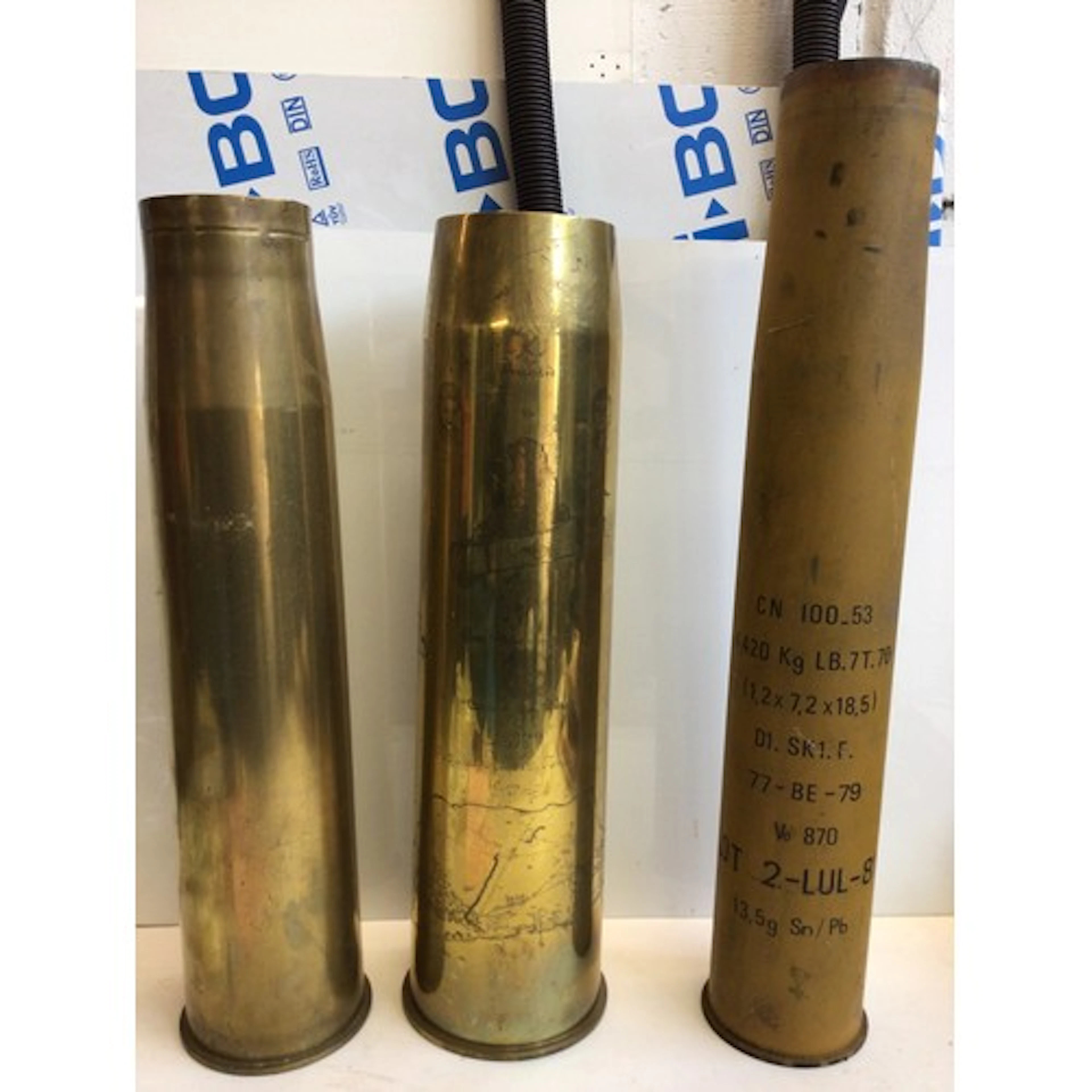 Three large Shell cases one with engraved decoration Two The...
