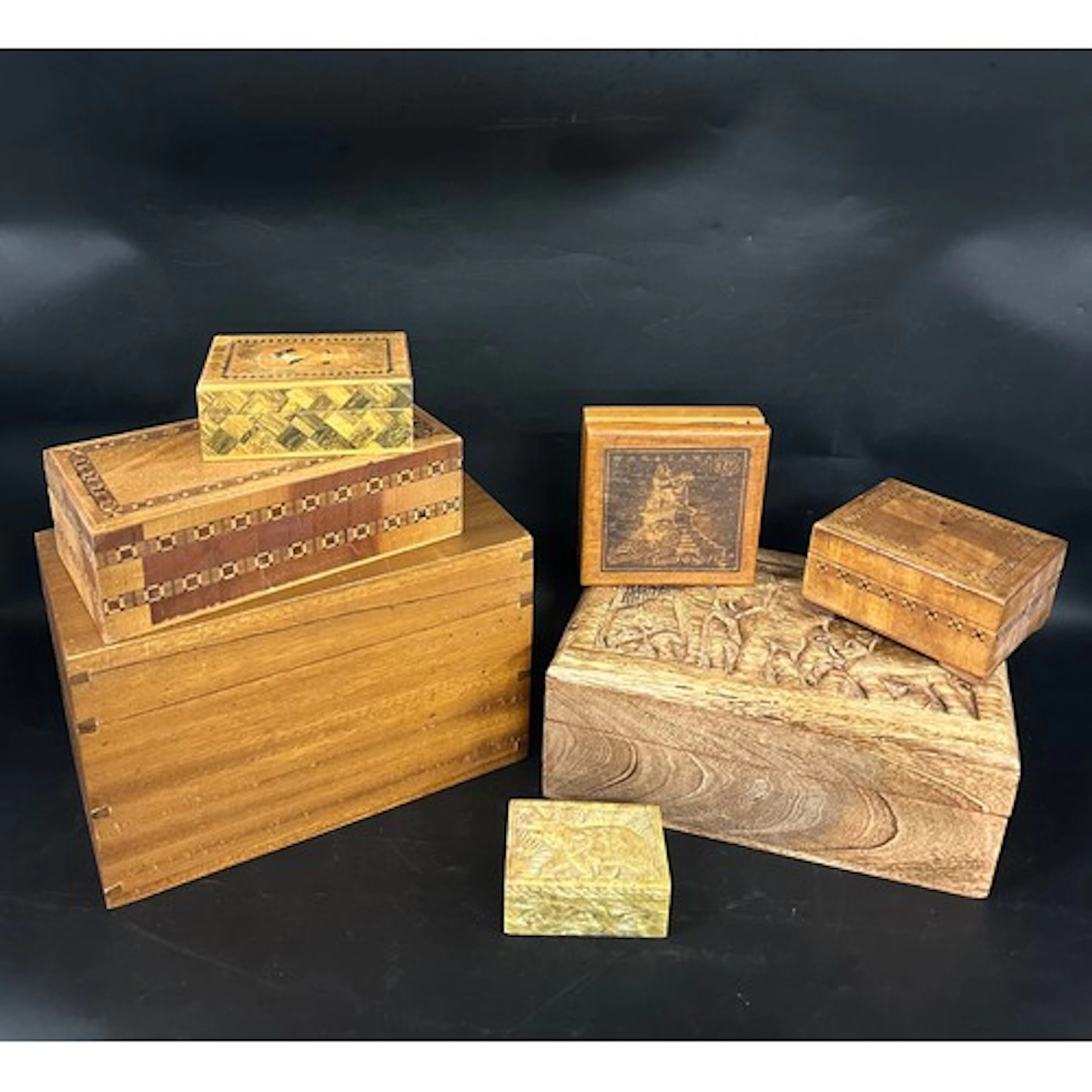 A collection of carved / inlaid wooden boxes and one soapsto...