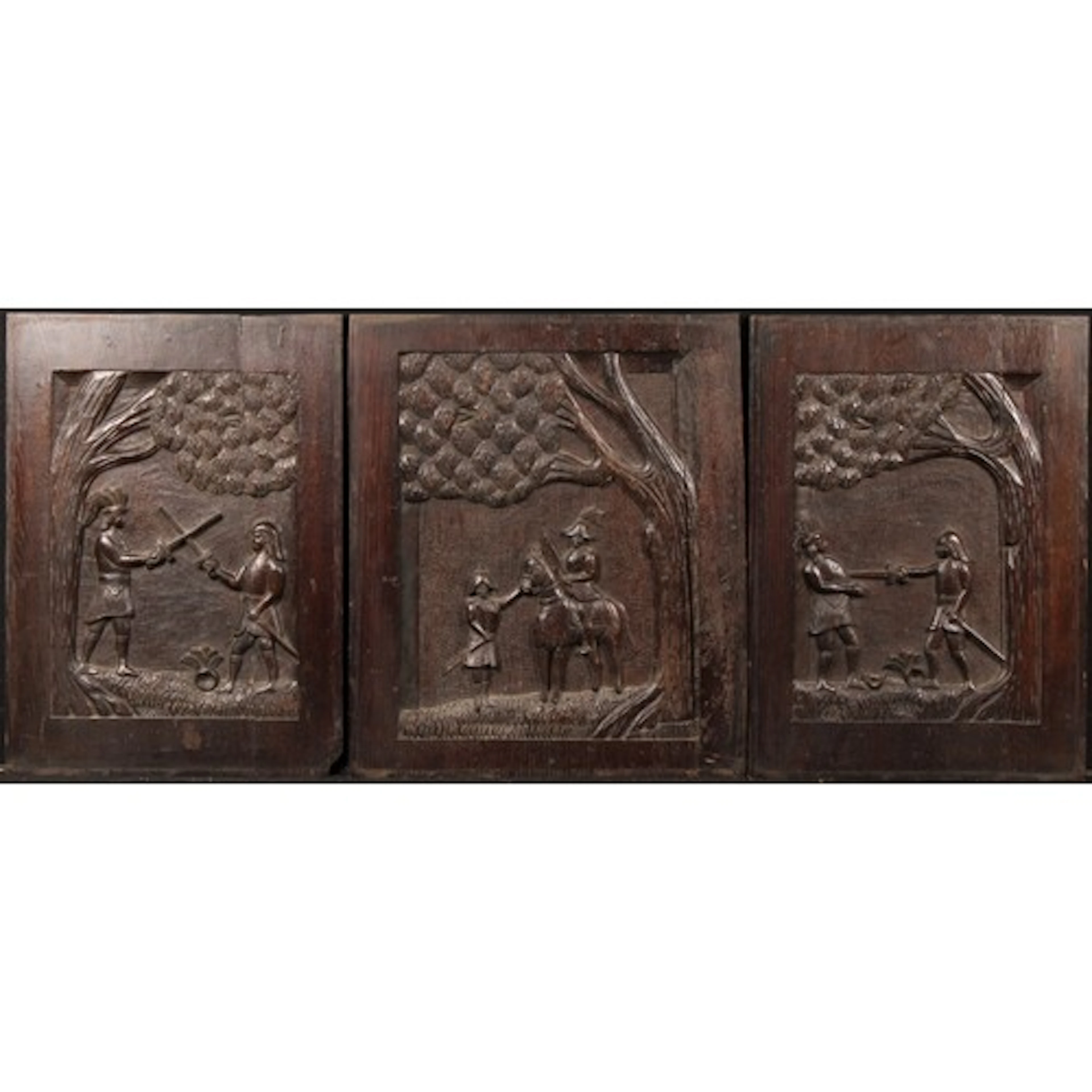 A 19th century garniture of three oak panels carved with Col...