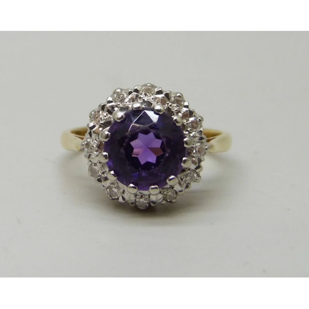 An 18ct gold, amethyst and diamond cluster ring, 3.9g, J/K