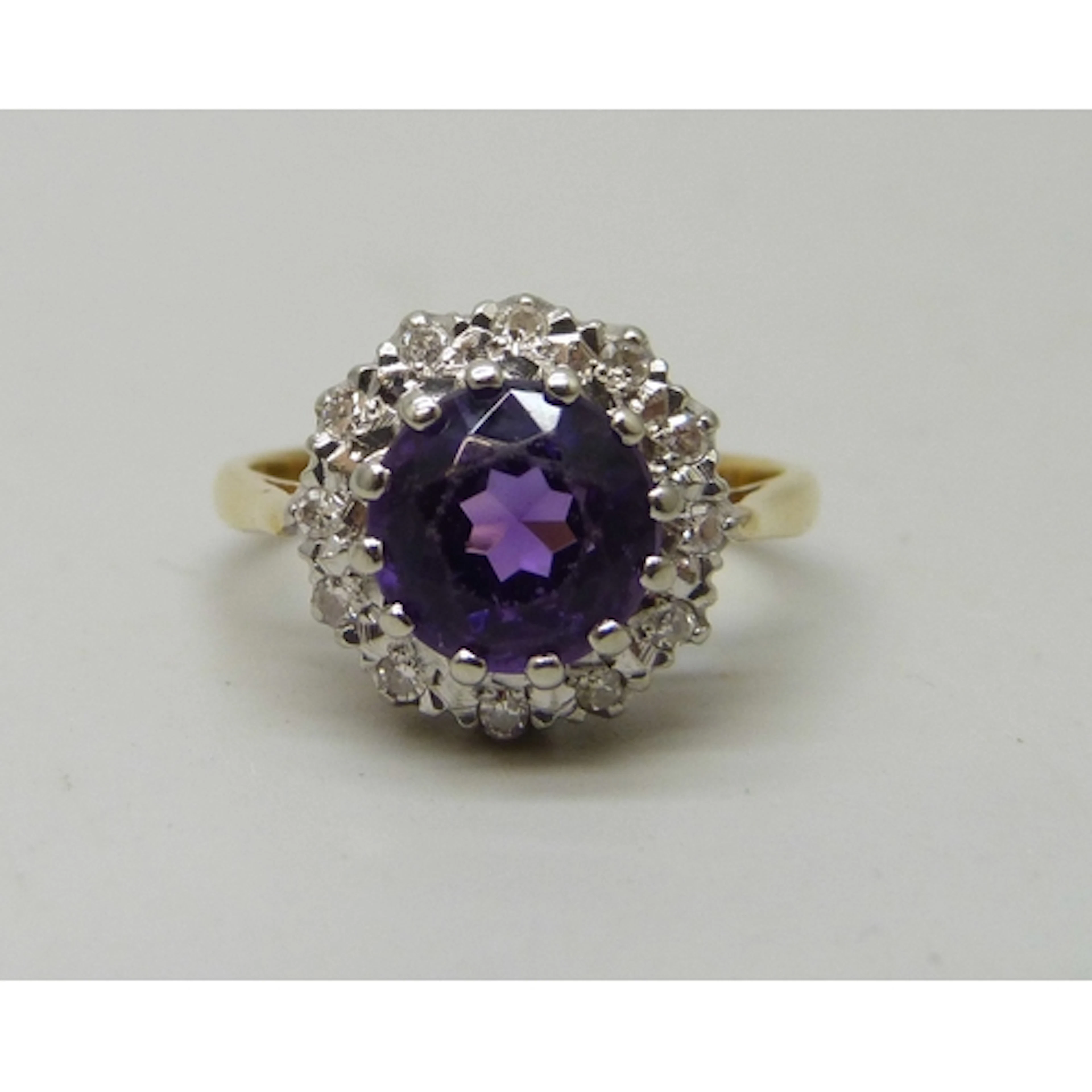 An 18ct gold, amethyst and diamond cluster ring, 3.9g, J/K