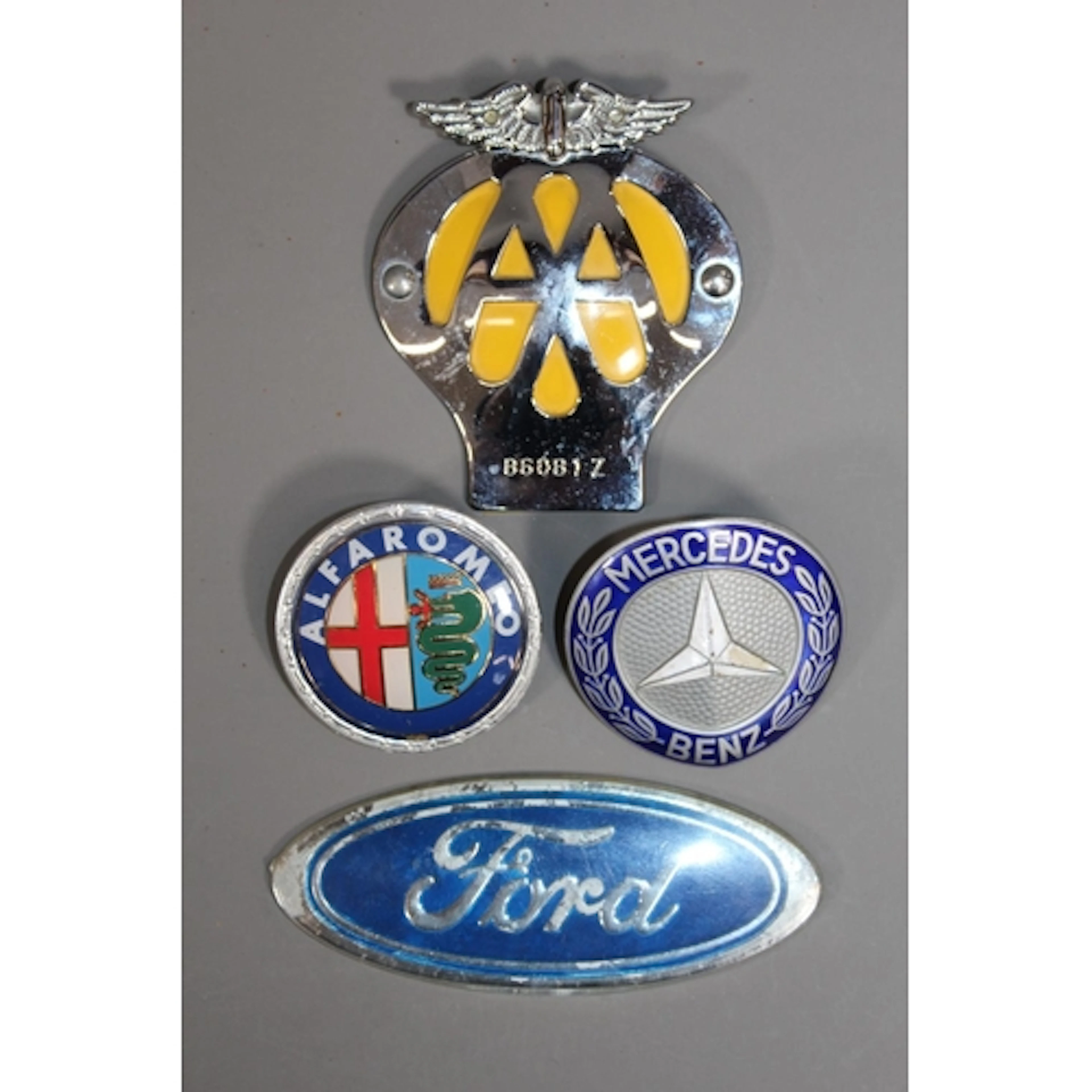 Four car badges to include Ford, Alfa Romeo, Mercedes Benz a...