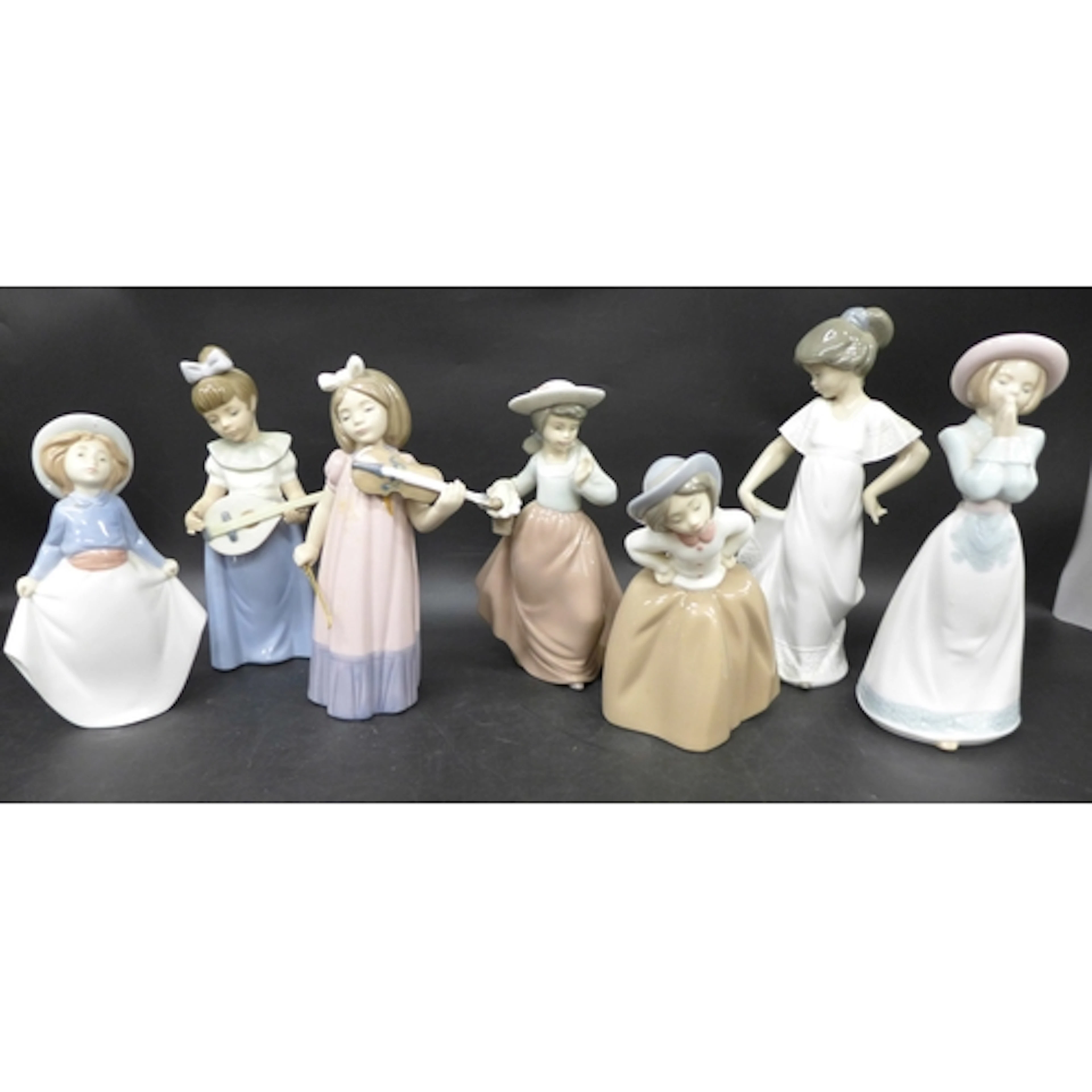 Seven Nao by Lladro figures, girls dancing and playing instr...