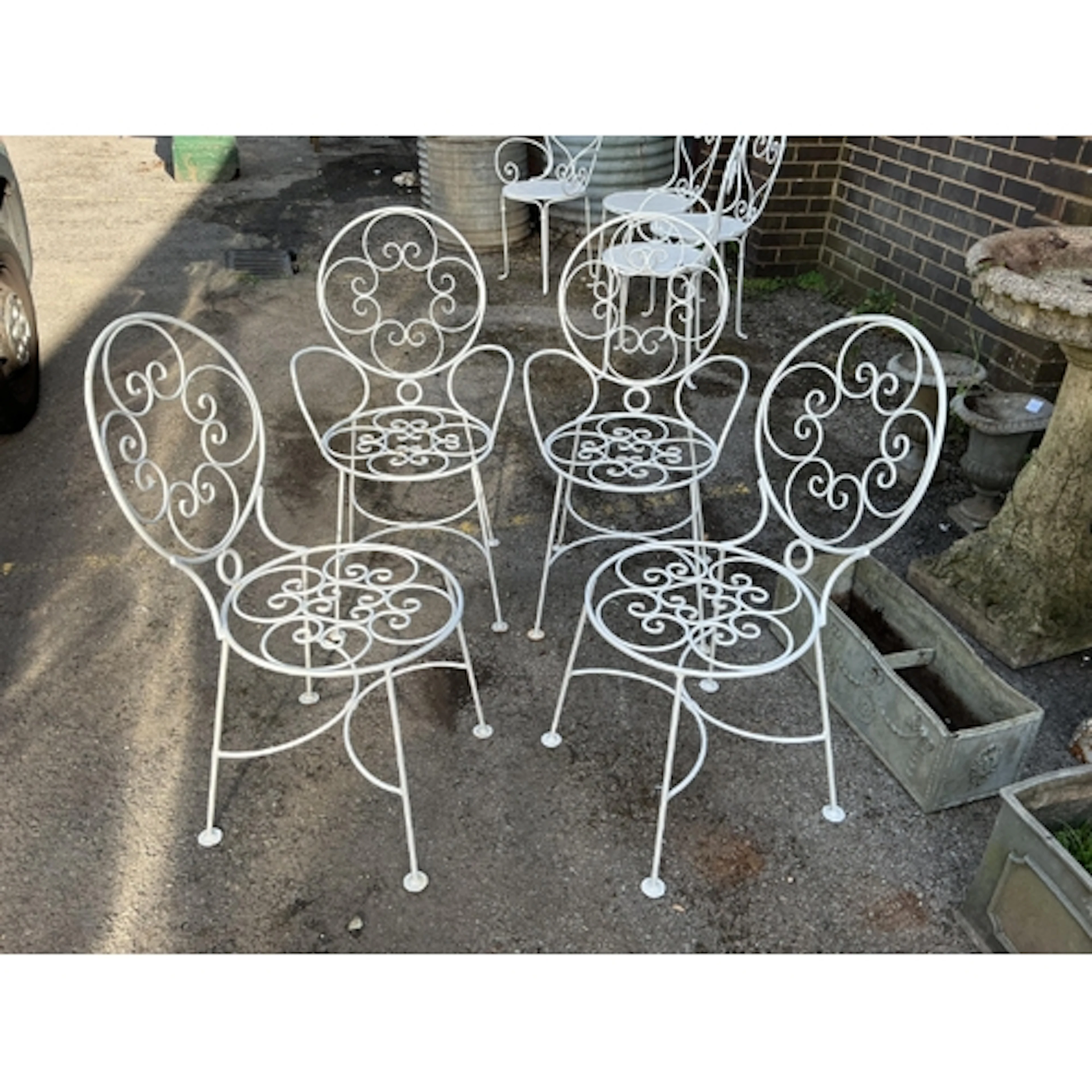 A set of four French wrought iron garden chairs, width 51cm,...
