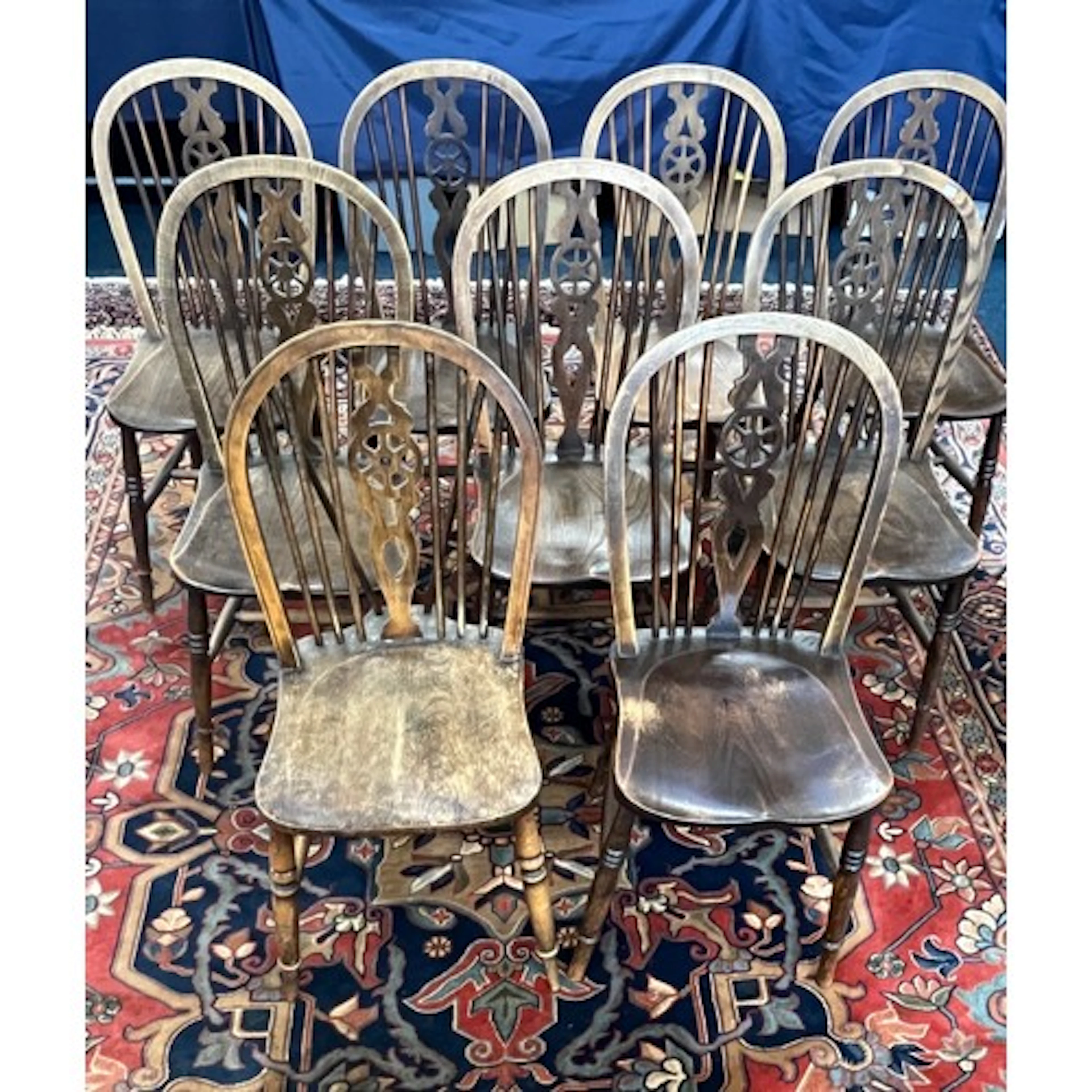 Set of nine wheel back Windsor chairs with carved central sp...