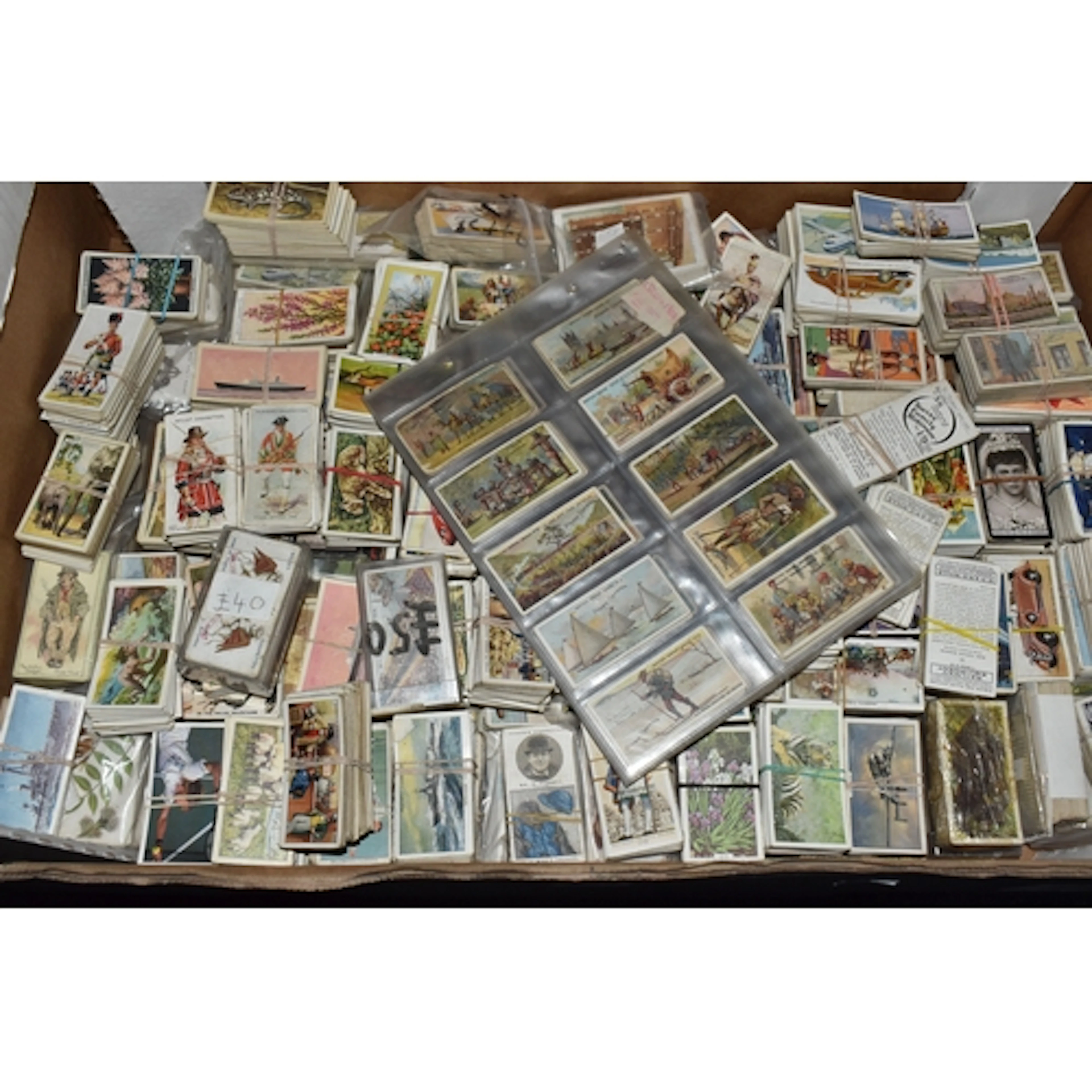 A BOX OF CIGARETTE & TRADE CARDS containing several thousand...