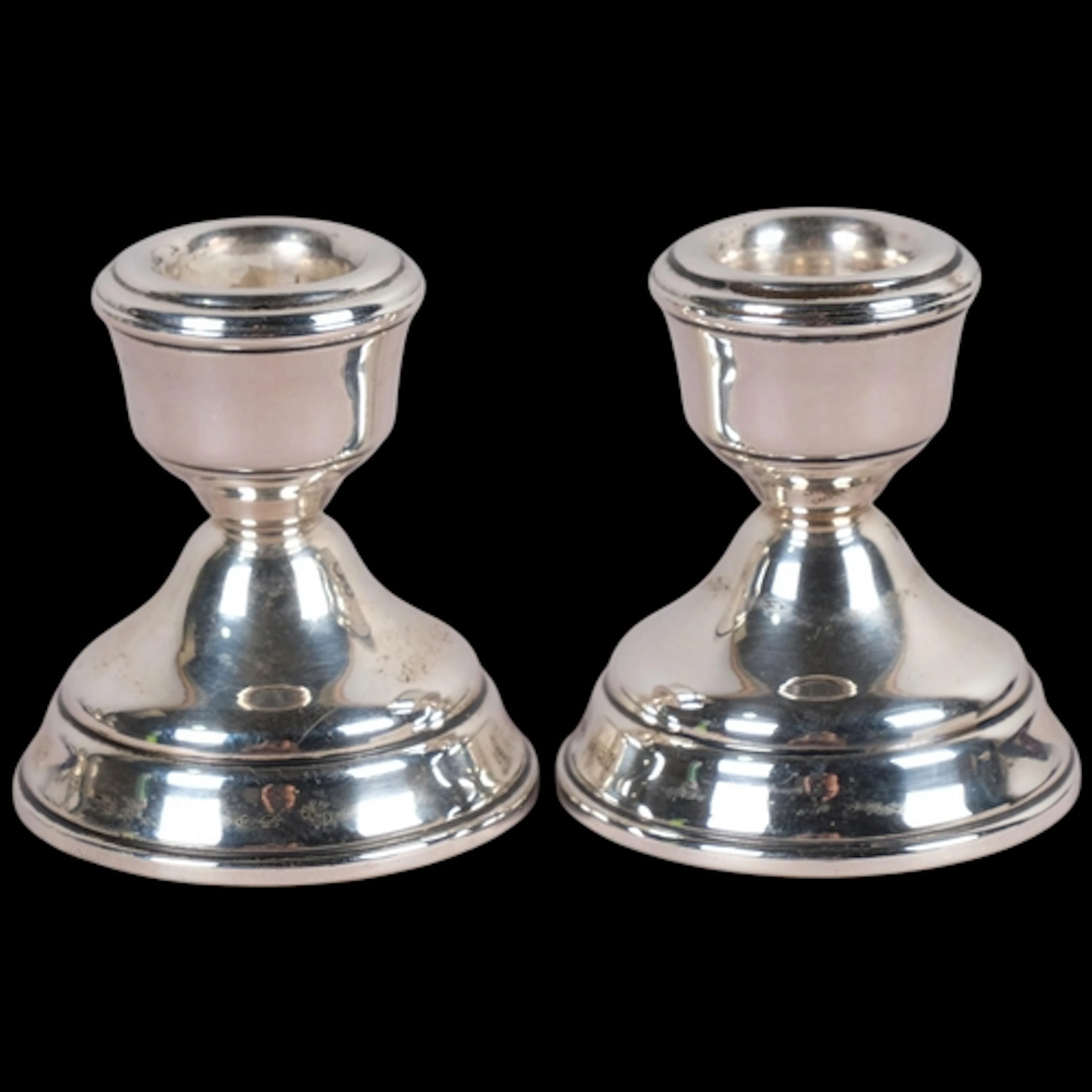 A pair of Elizabeth II silver squat table candlesticks, W I ...