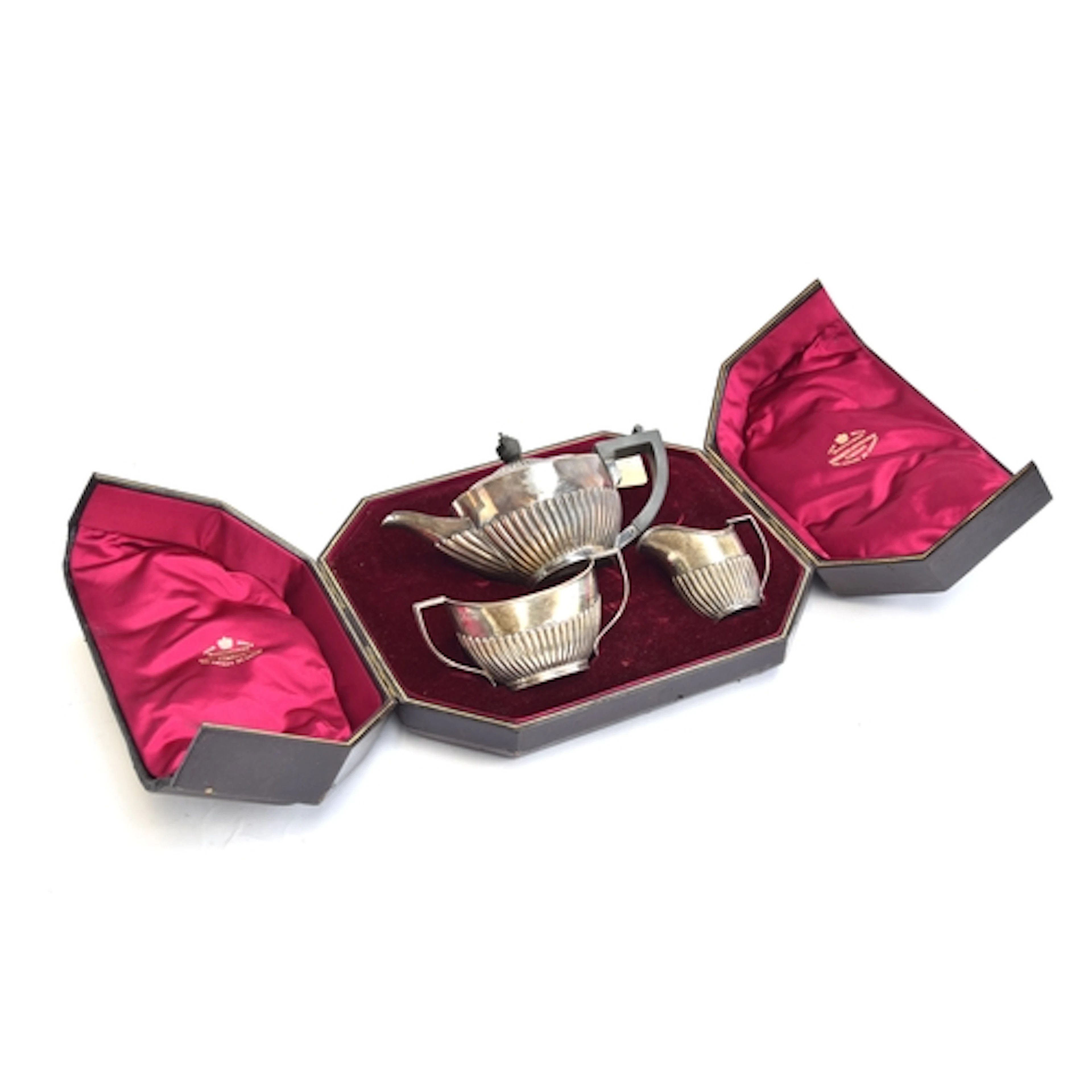 A cased three piece bachelor's silver tea set, by Goldsmiths...