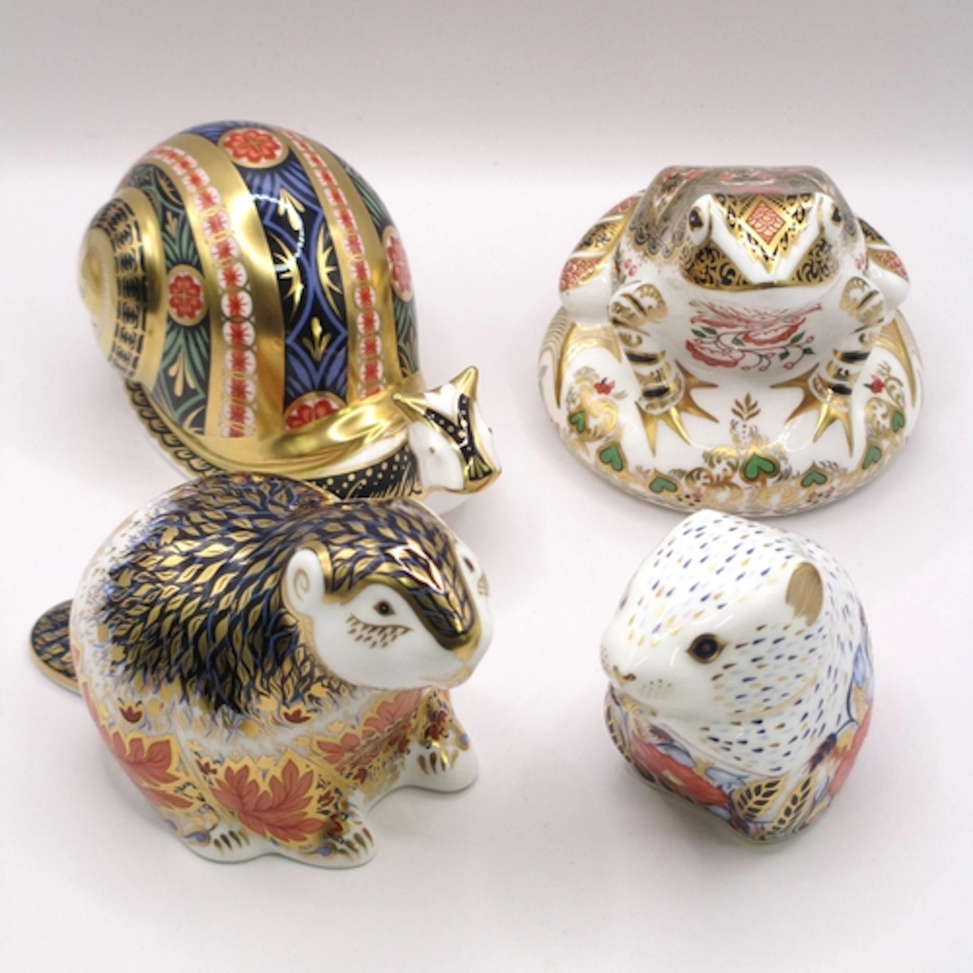 Group of four Royal Crown Derby paperweights, all with gold ...