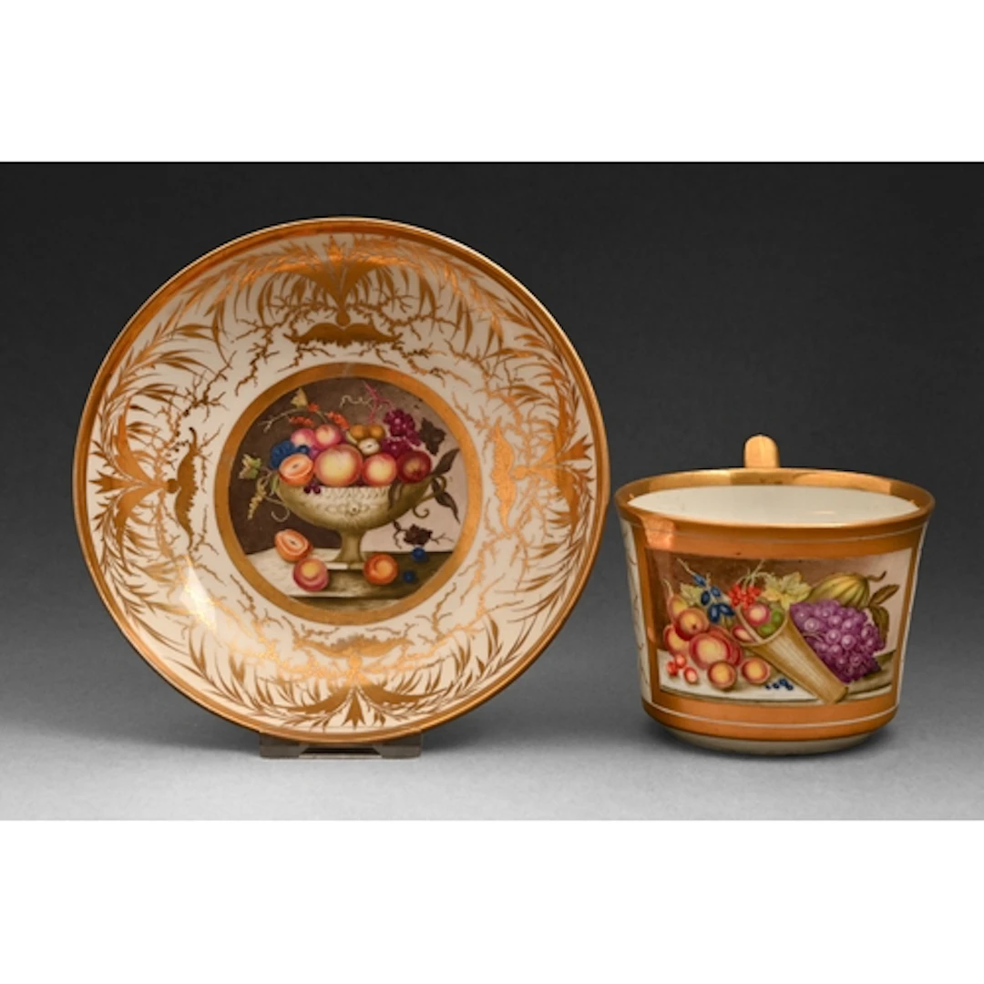 A Derby teacup and saucer, c1810, painted by John Brewer wit...