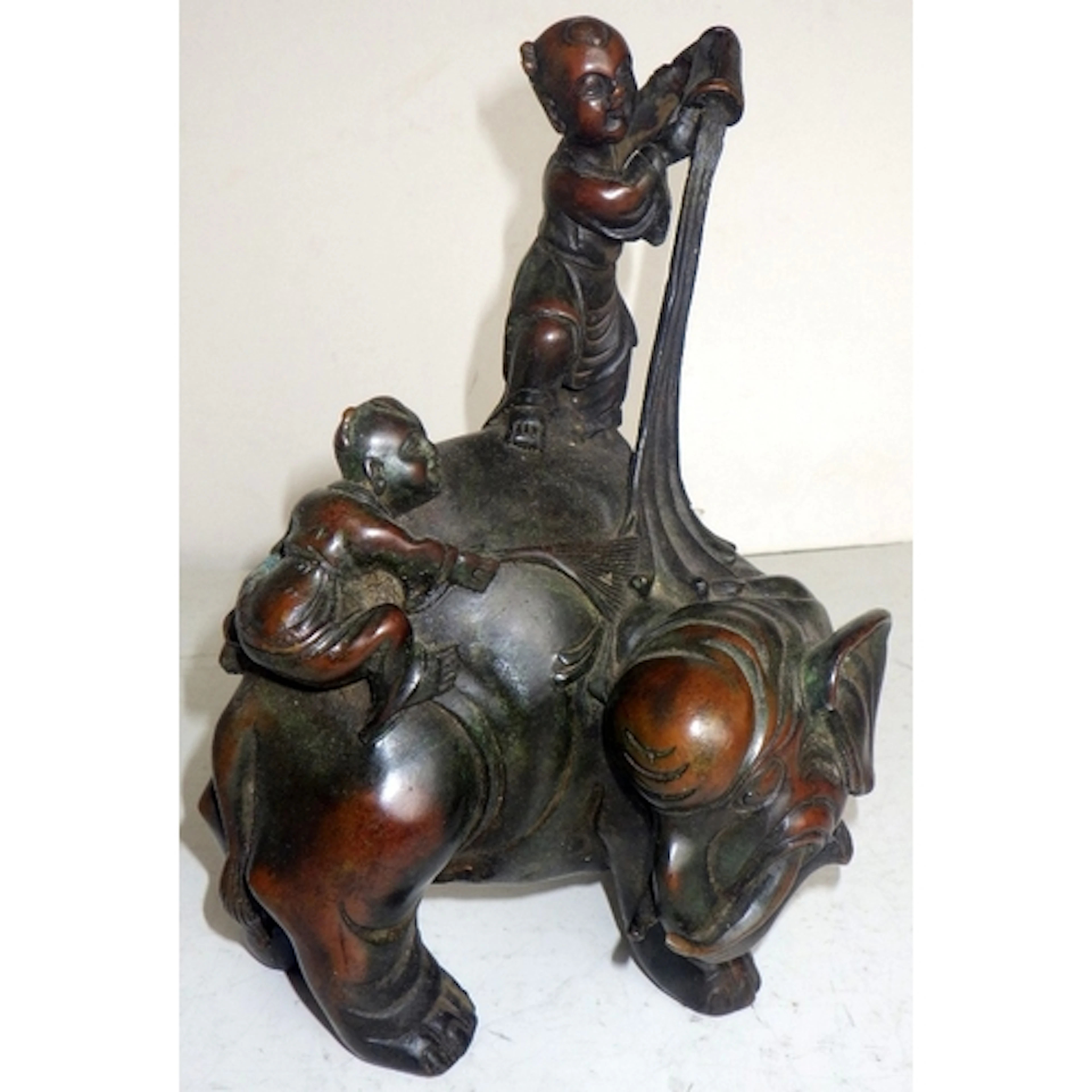 A Chinese cast bronze figure of an elephant & children, 23cm...