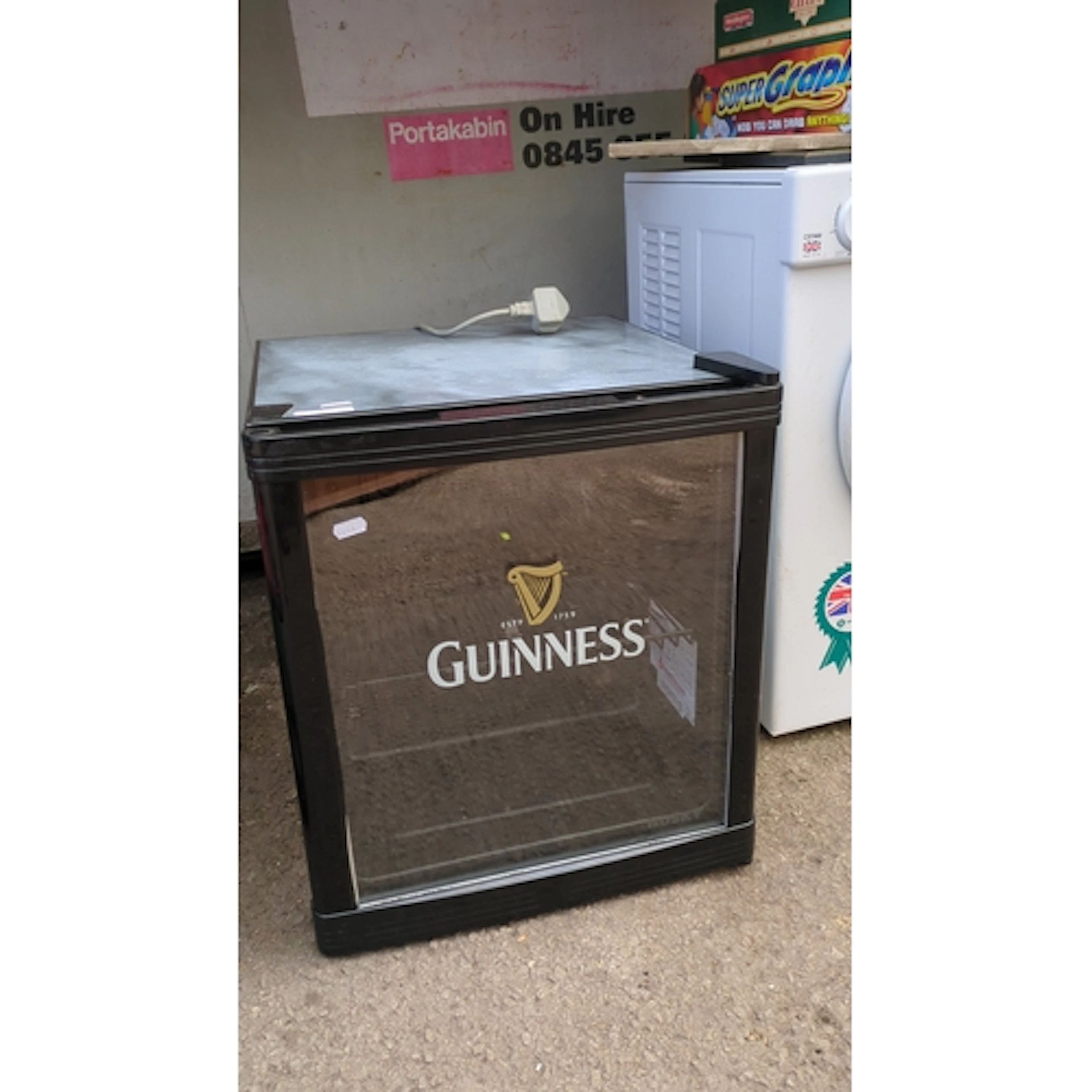 Guinness-branded countertop display refrigerator with glazed...