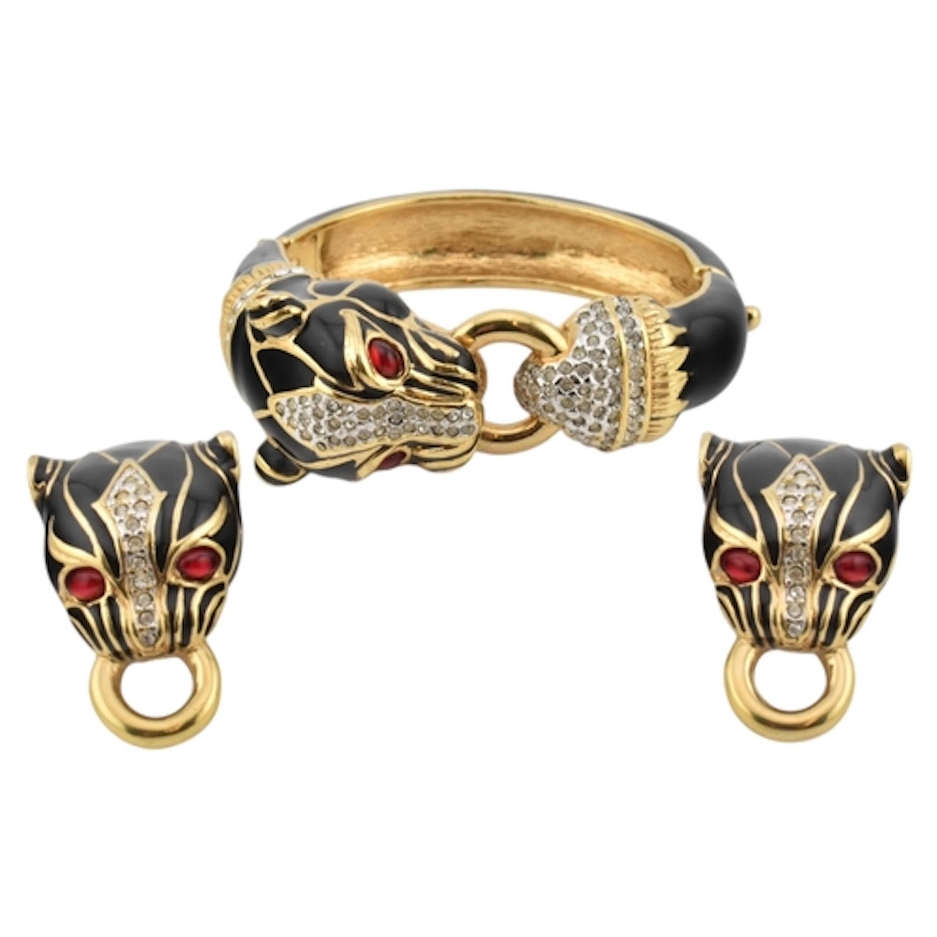 A gold tone and black enamel panther hinged bangle and clip-...