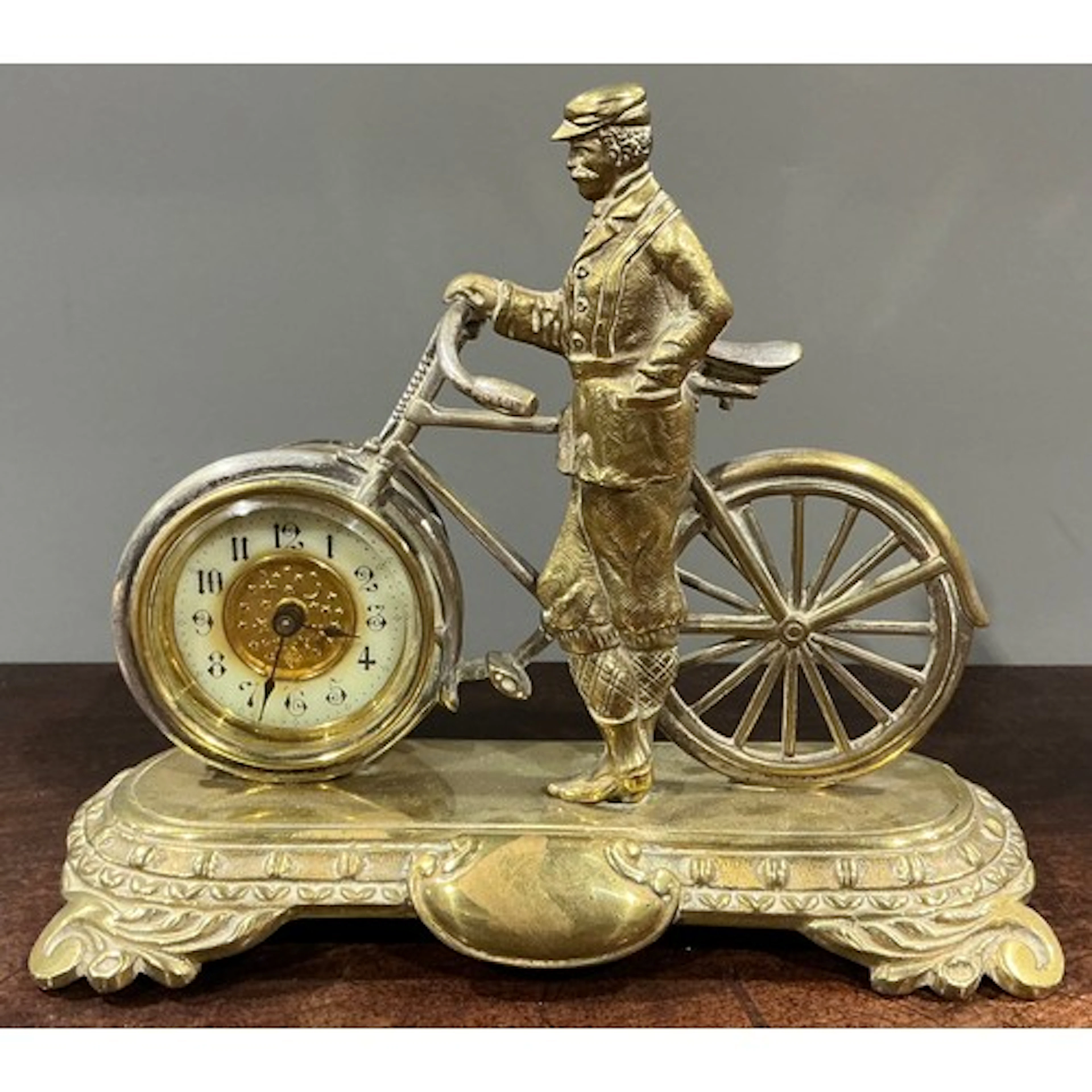 An early 20th century brass novelty desk timepiece, of cycli...