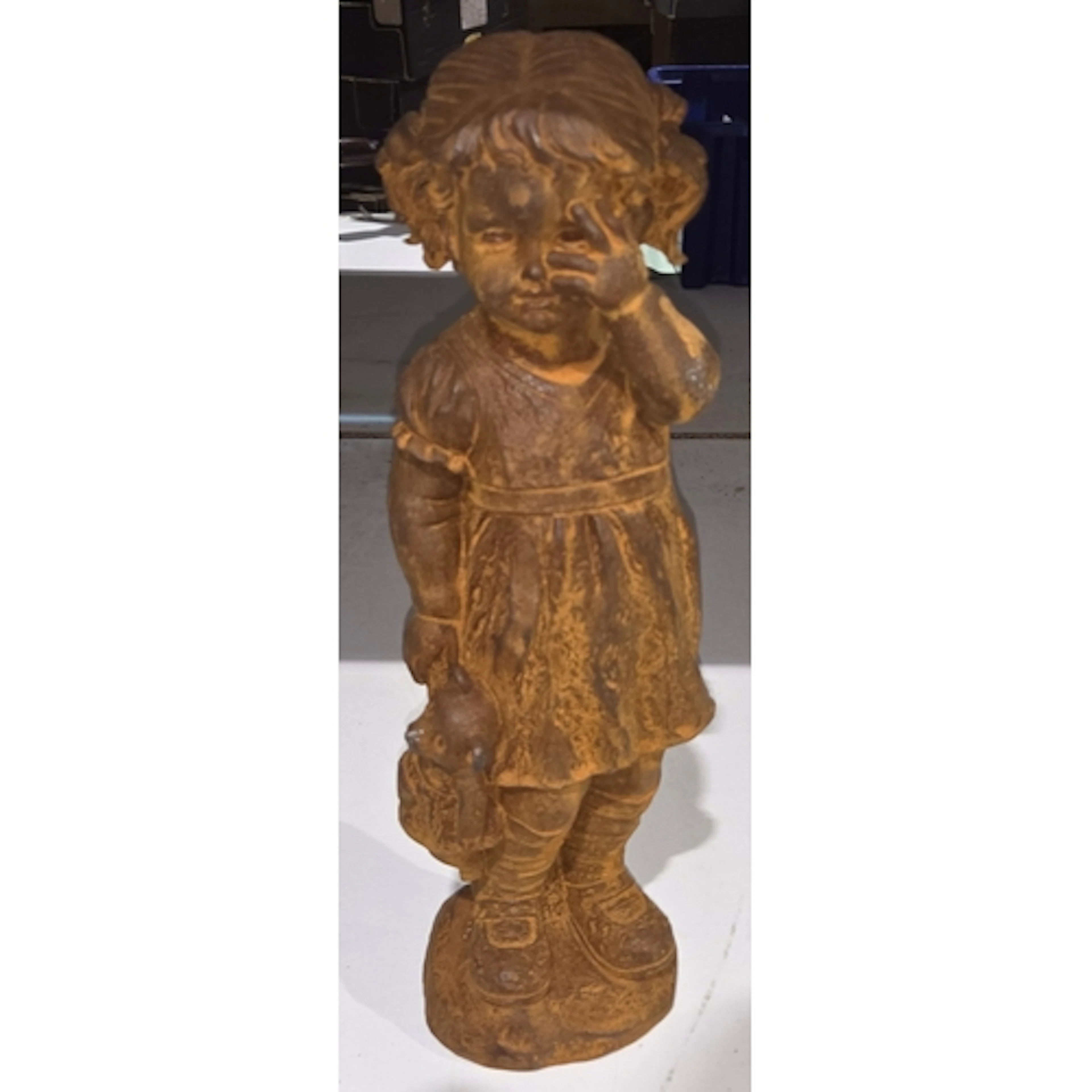 A 19th century oxidised cast metal figure of a girl with ted...