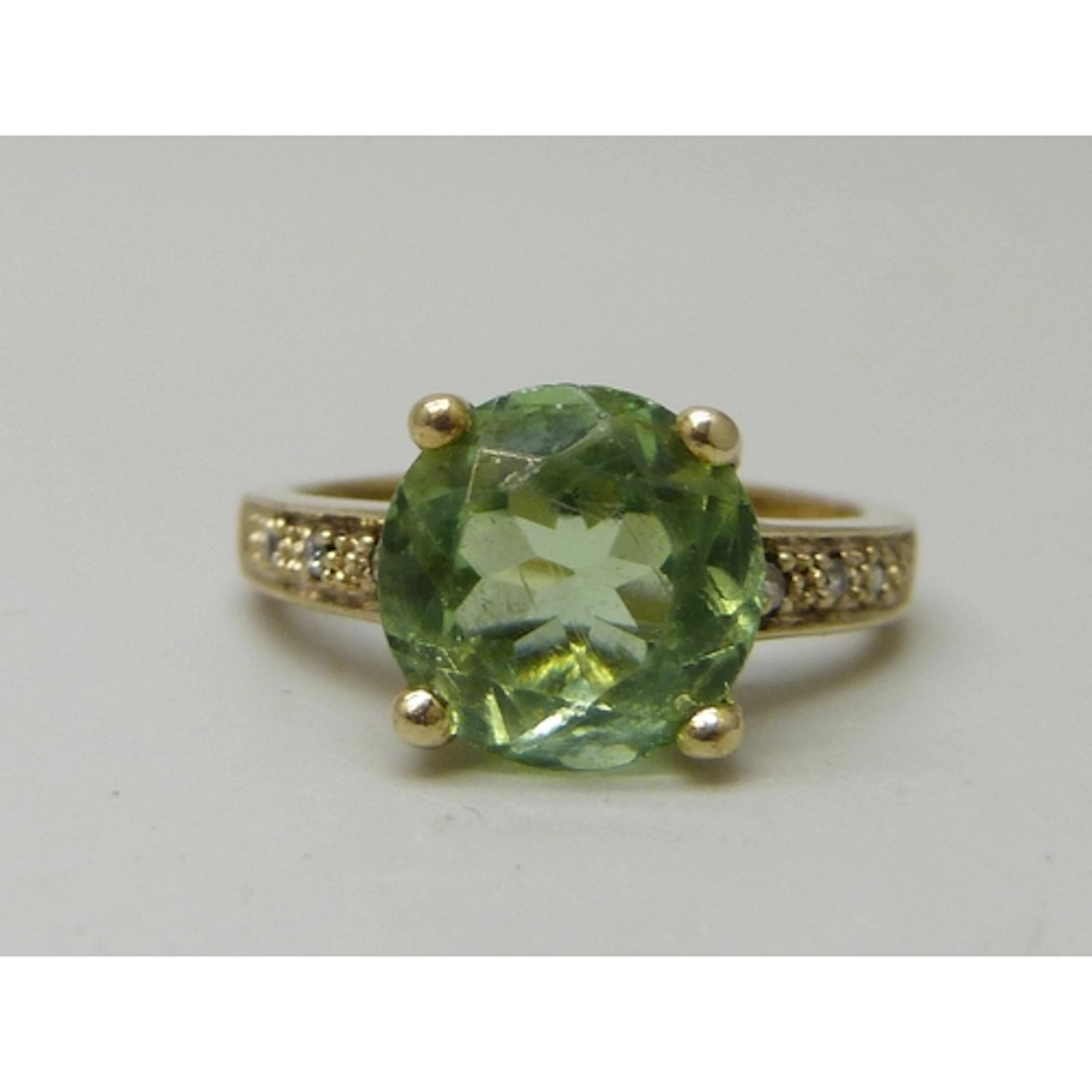 A silver gilt green and white stone ring, M/N