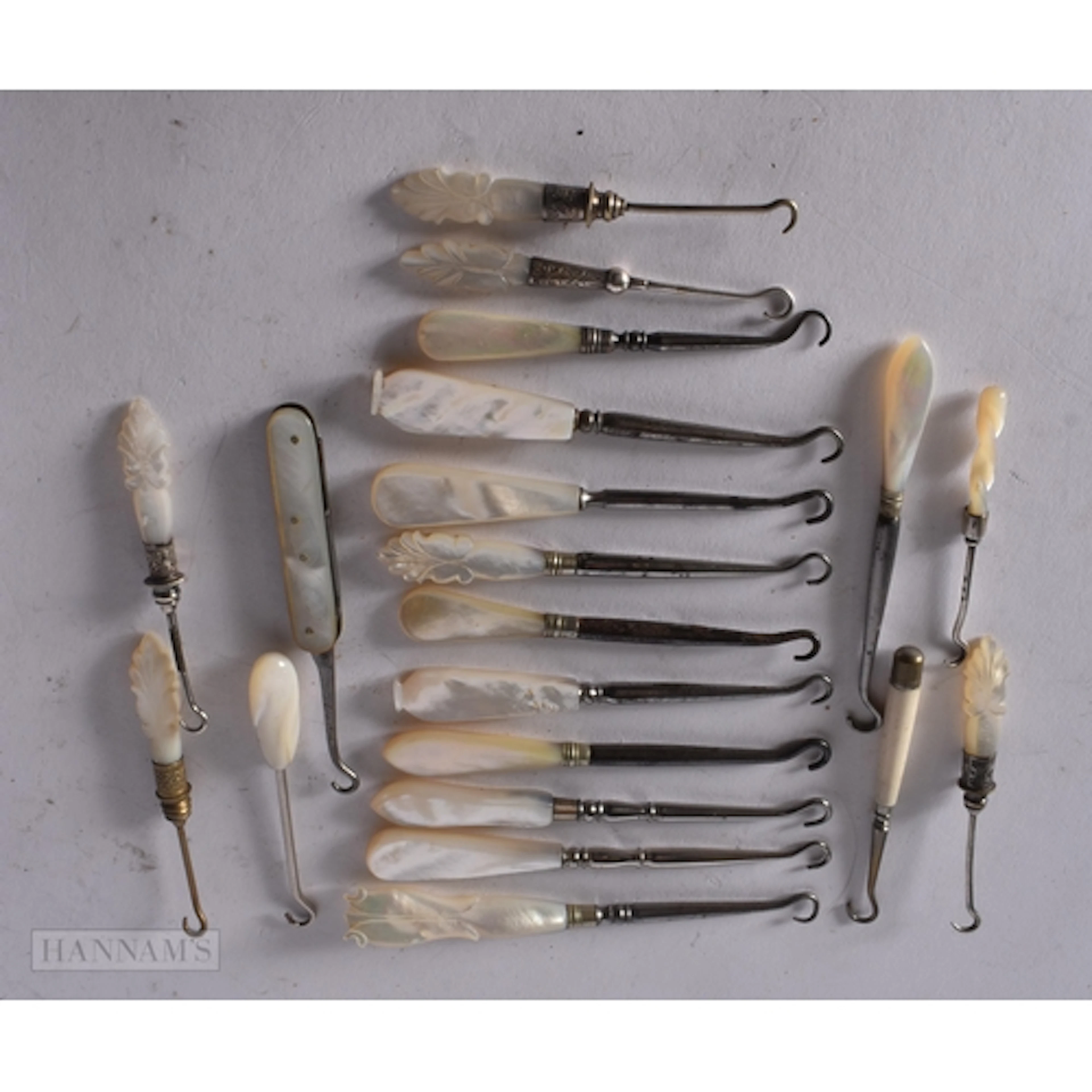 A GROUP OF ANTIQUE MOTHER OF PEARL HANDLED BUTTON HOOKS. (qt...