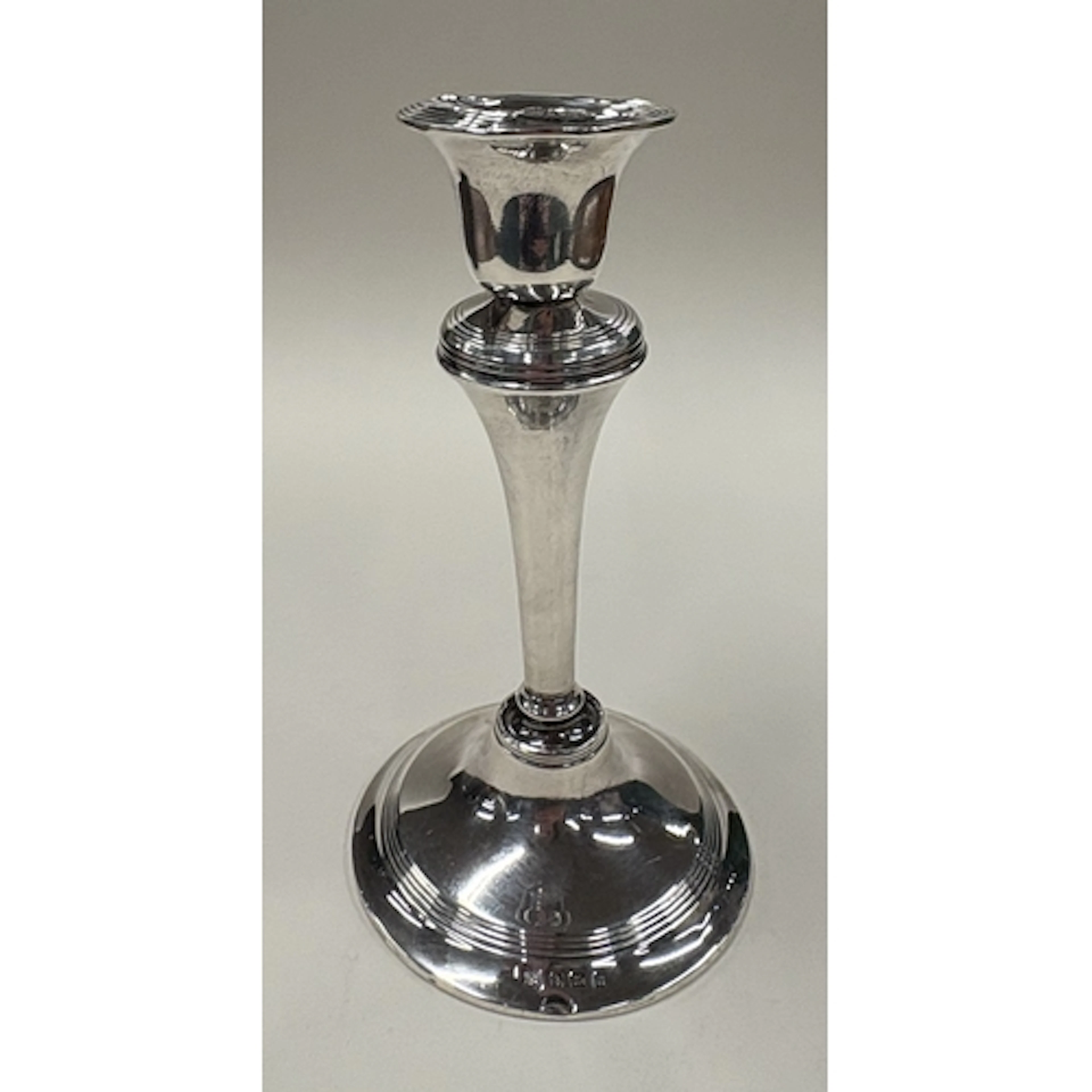 A silver candlestick. Birmingham 1912. By W J Myatt & Co. Ap...