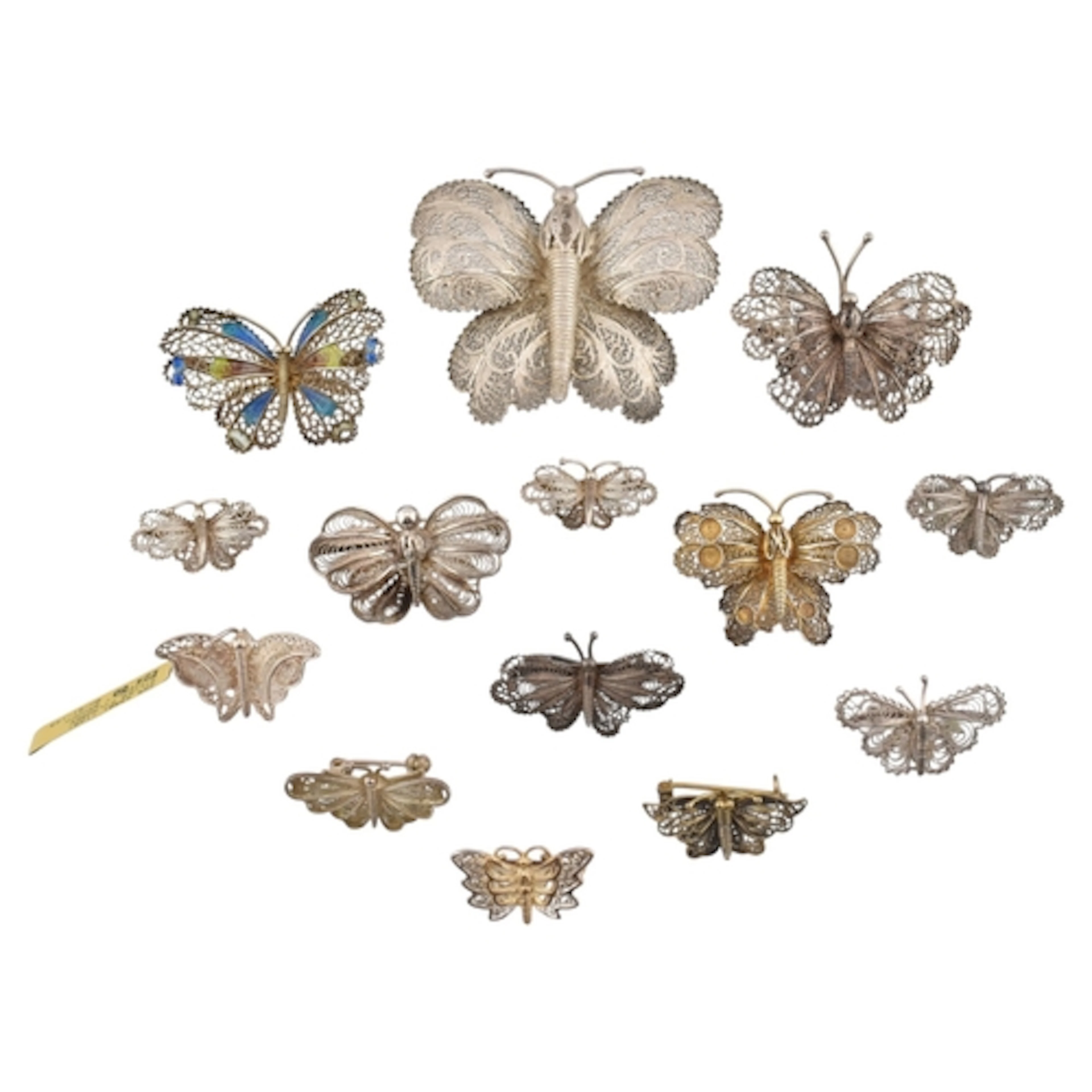 A collection of filigree butterfly brooch pins. Nine small, ...