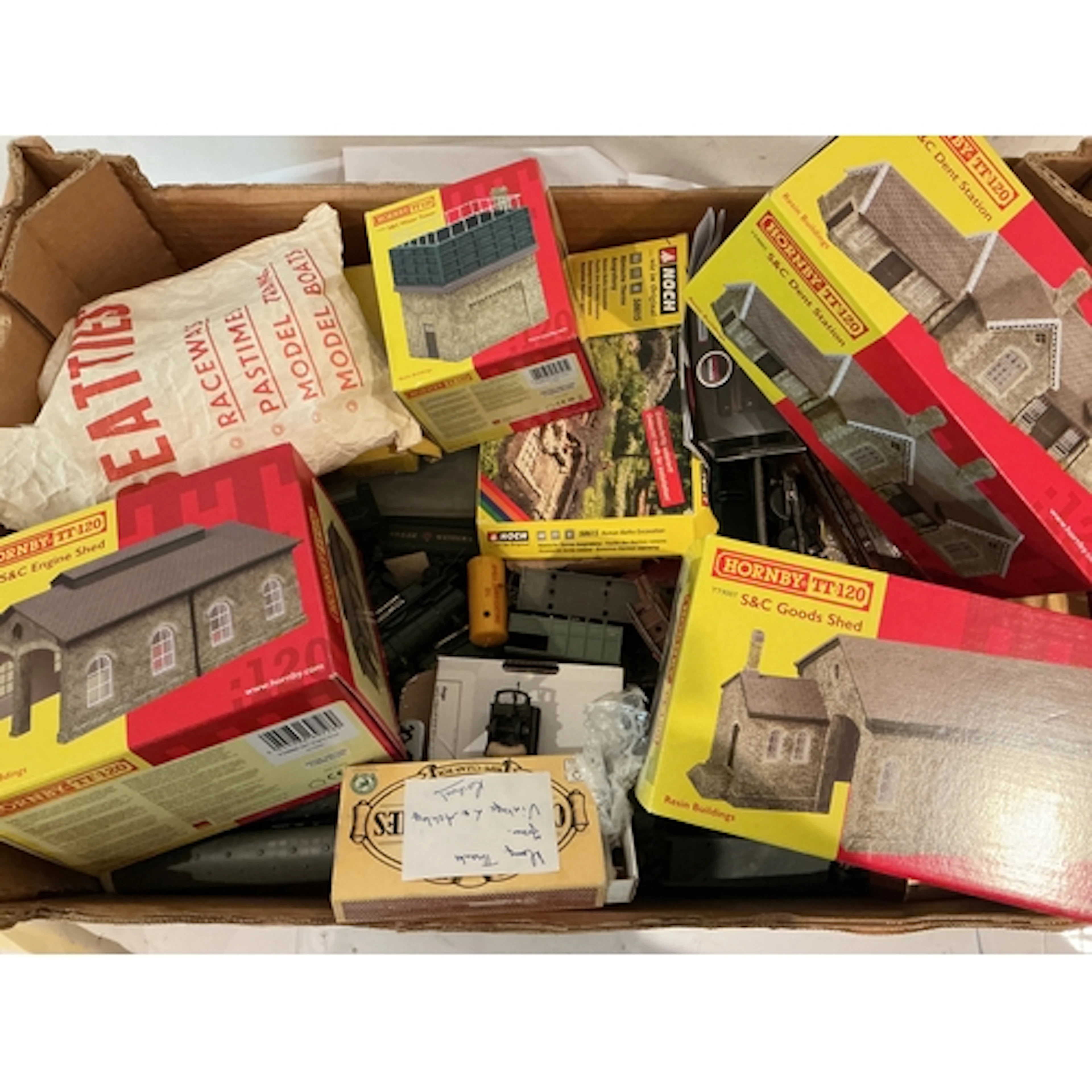 A Crate Containing TT Gauge Spare Parts And Boxed Buildings.