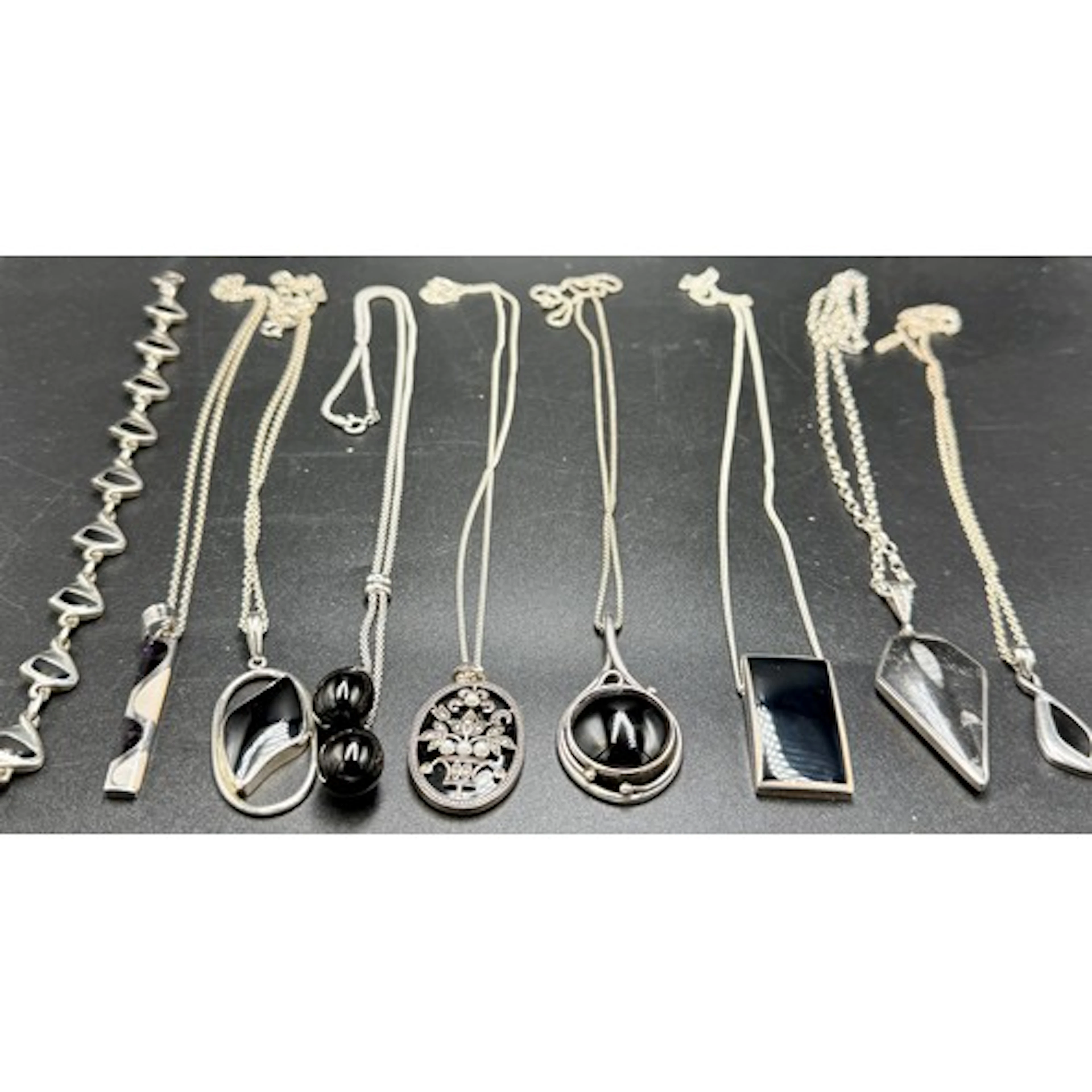 Eight sterling silver pendant necklaces on sterling silver c...