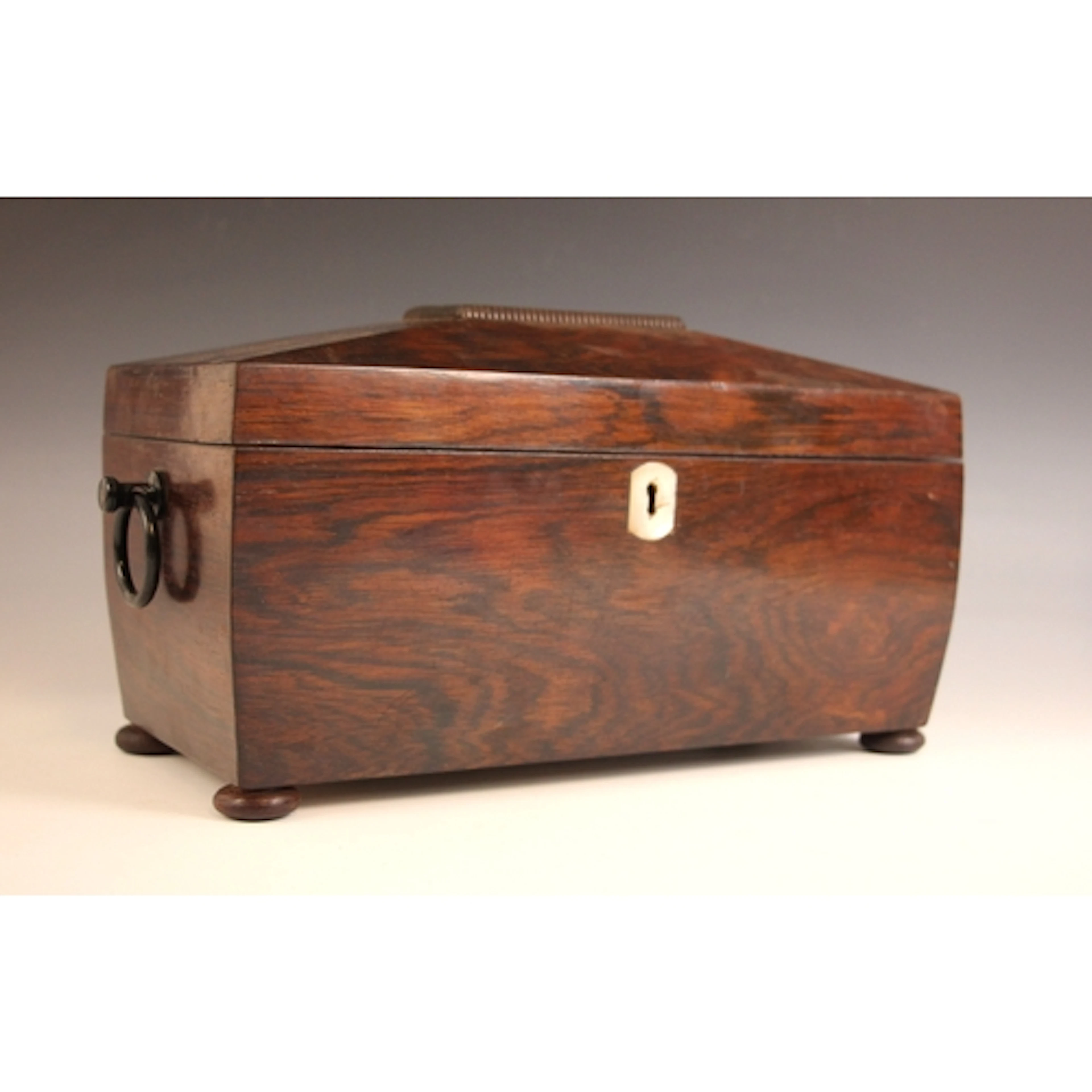 A William IV rosewood tea caddy, the sarcophagus shaped cadd...