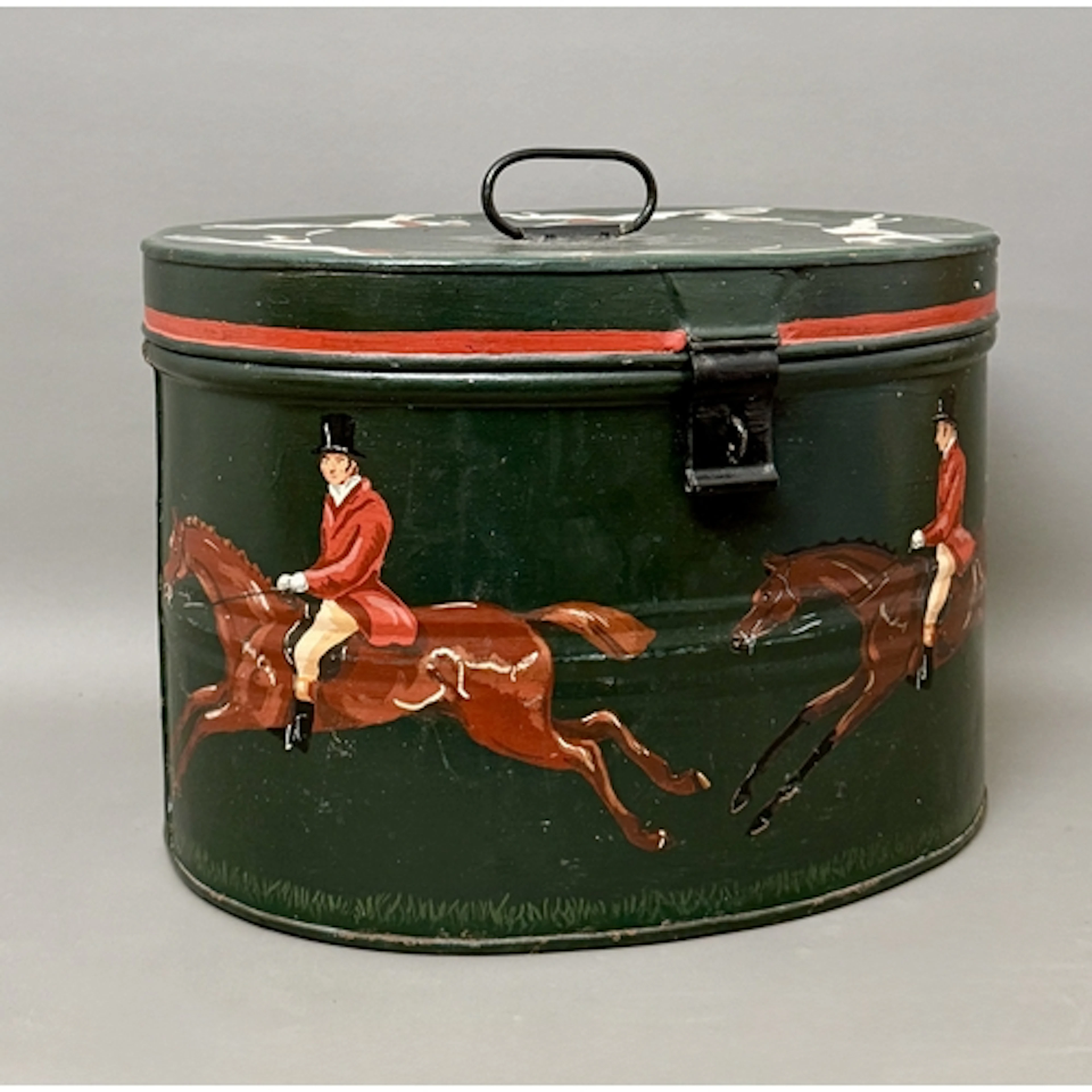 A vintage oval tin hat box with hand painted decoration of h...