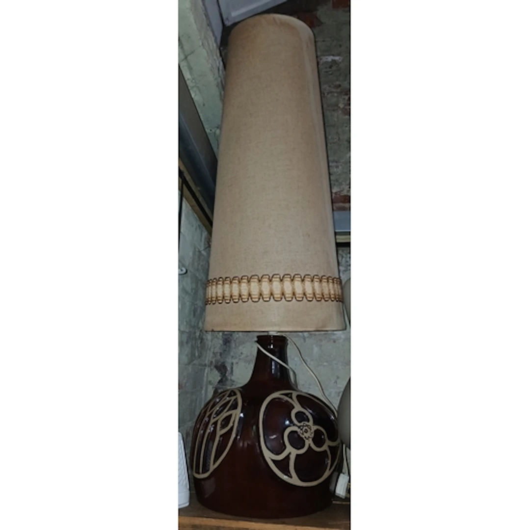 A retro pottery floor standing lamp and shade.