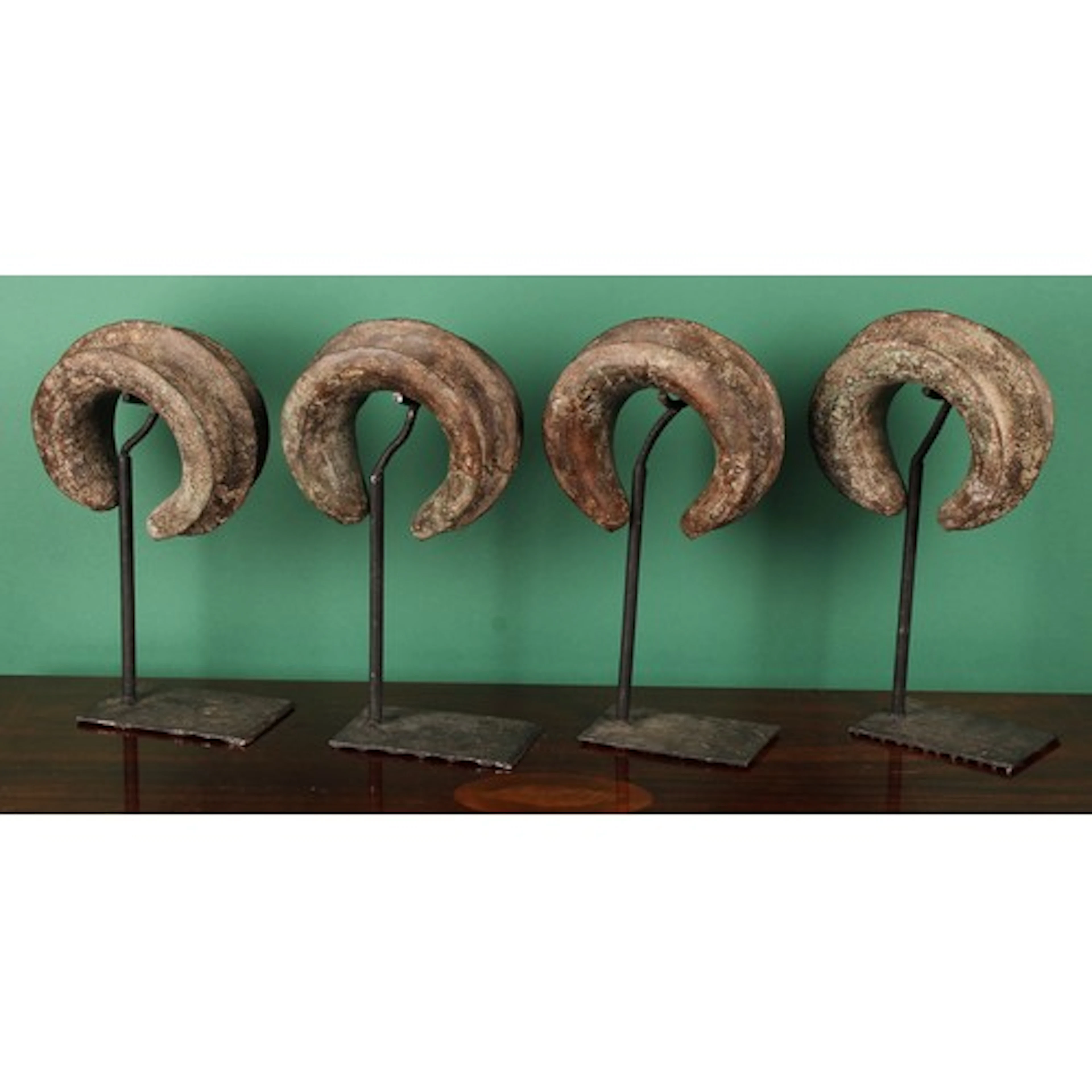 A set of four substantial West African bronze manilla curren...