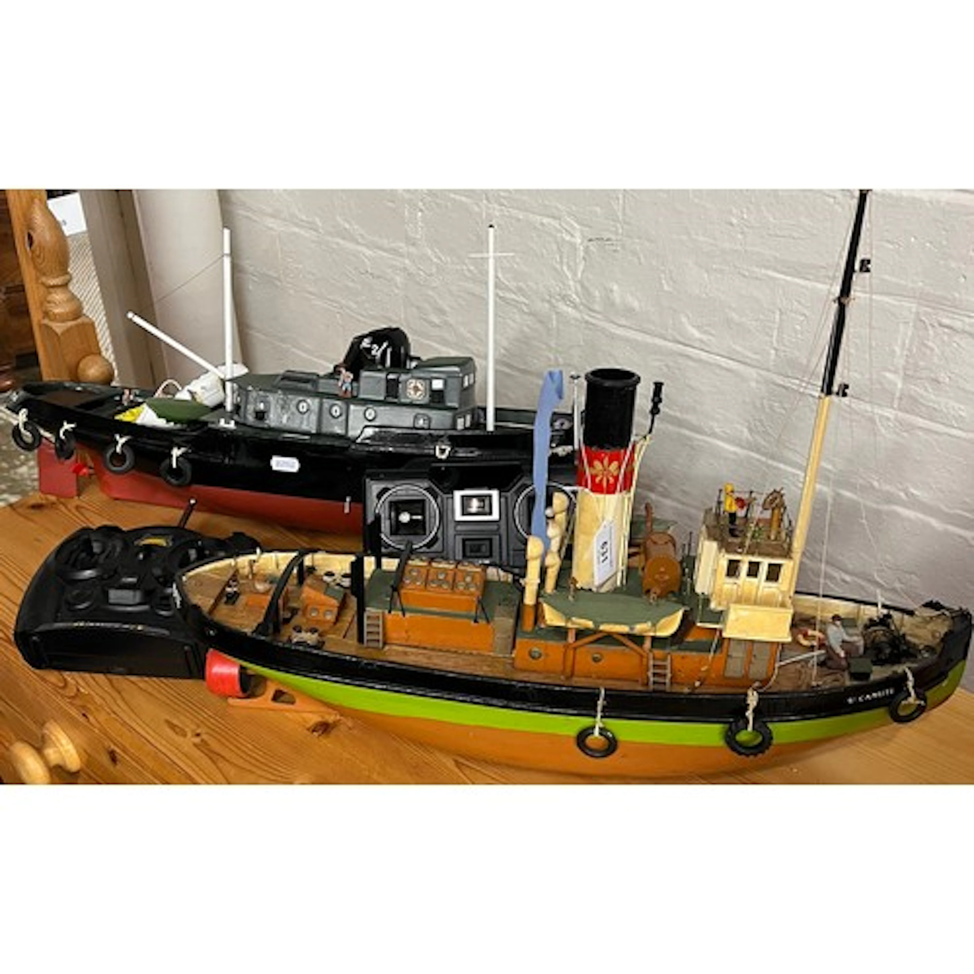Two model radio control boats, with controls. (2)