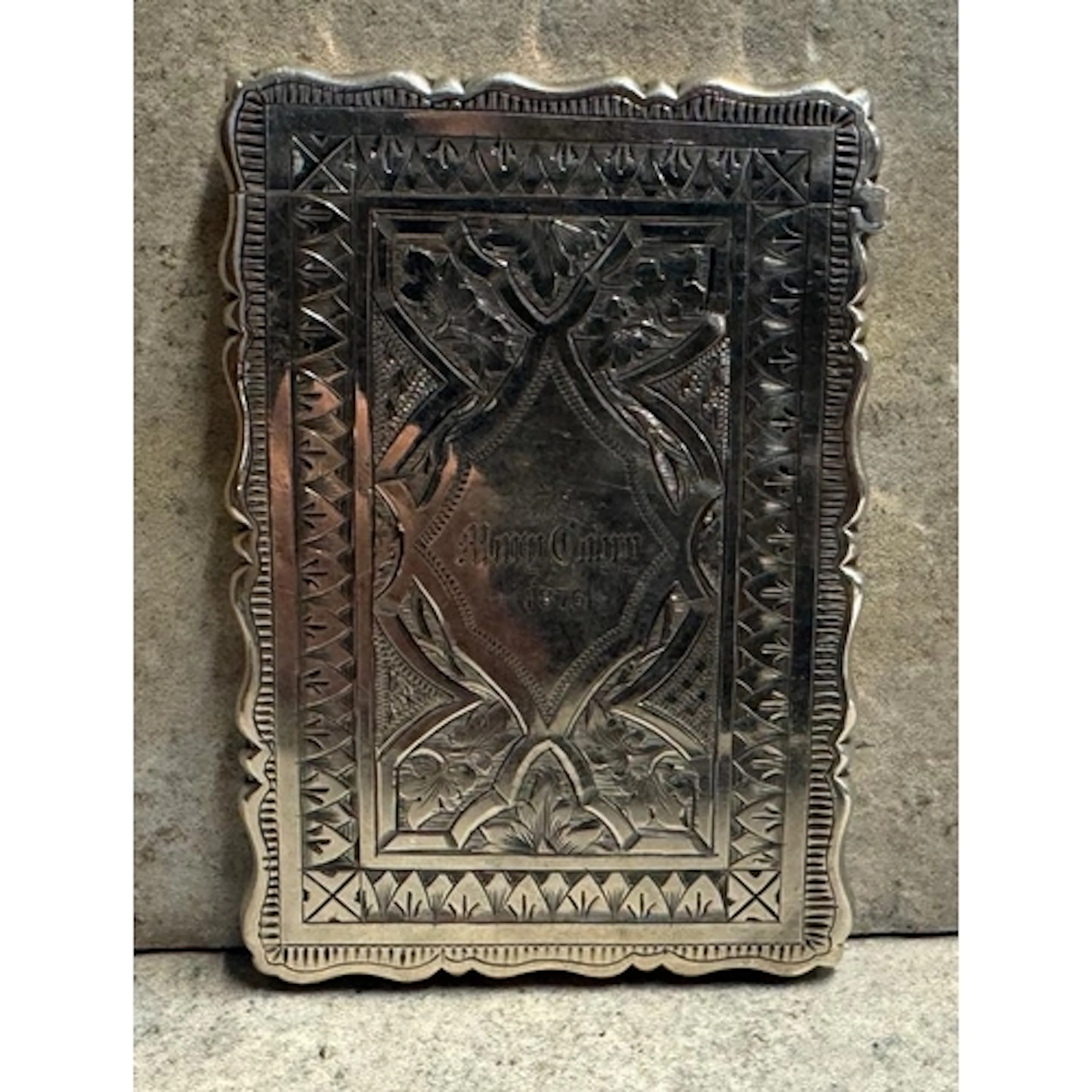 A Victorian silver engraved card case with floral decoration...
