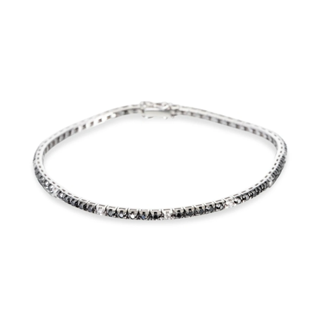 A BLACK & WHITE DIAMOND LINE BRACELET, the round cut black d...
