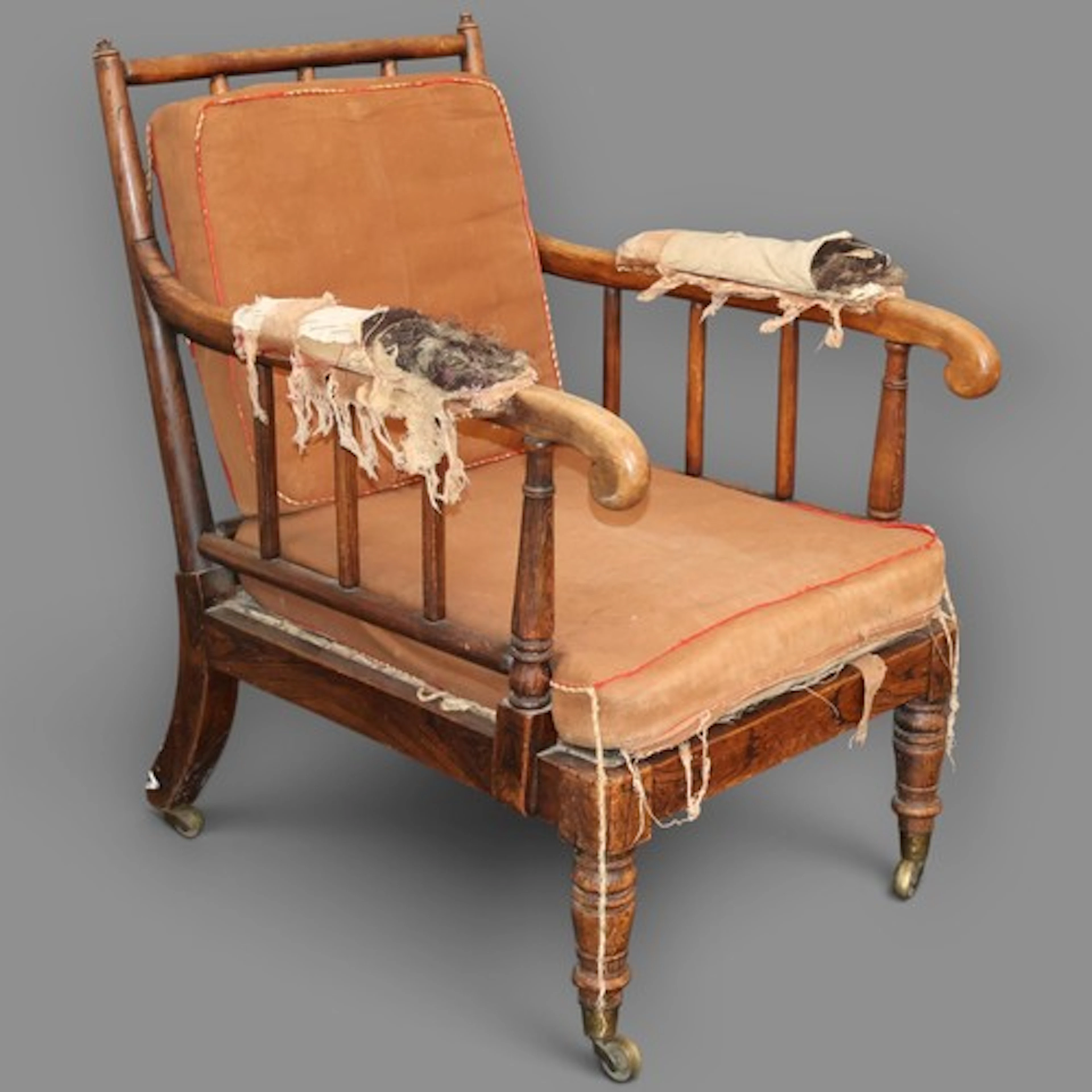 A Regency Period stick and rail back library lounge chair in...