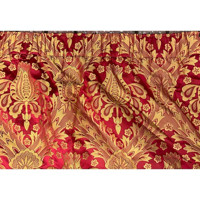 A large damask red and gold full length curtain, of baroque ...