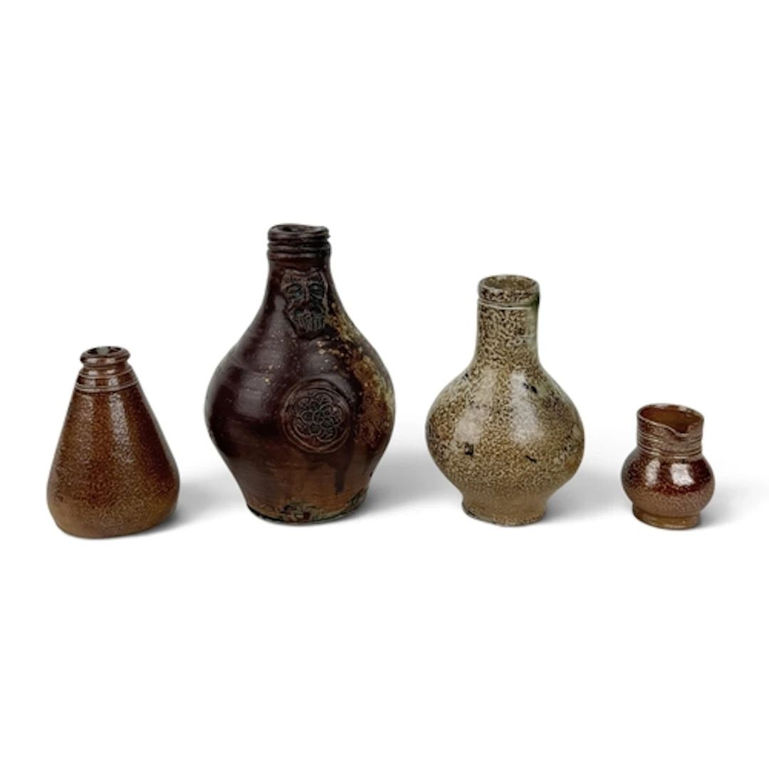 A GROUP OF RHENISH AND BRITISH SALT-GLAZED STONEWARE VESSELS...