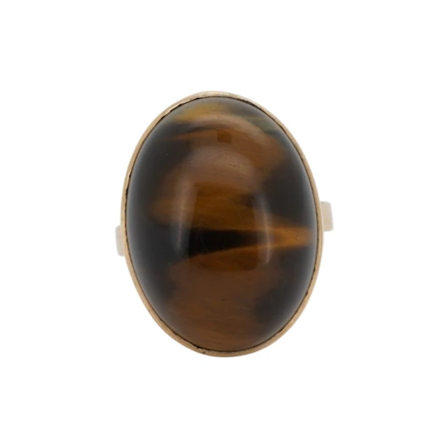 A 9ct and single stone cabochon tiger's eye quartz set ring,...