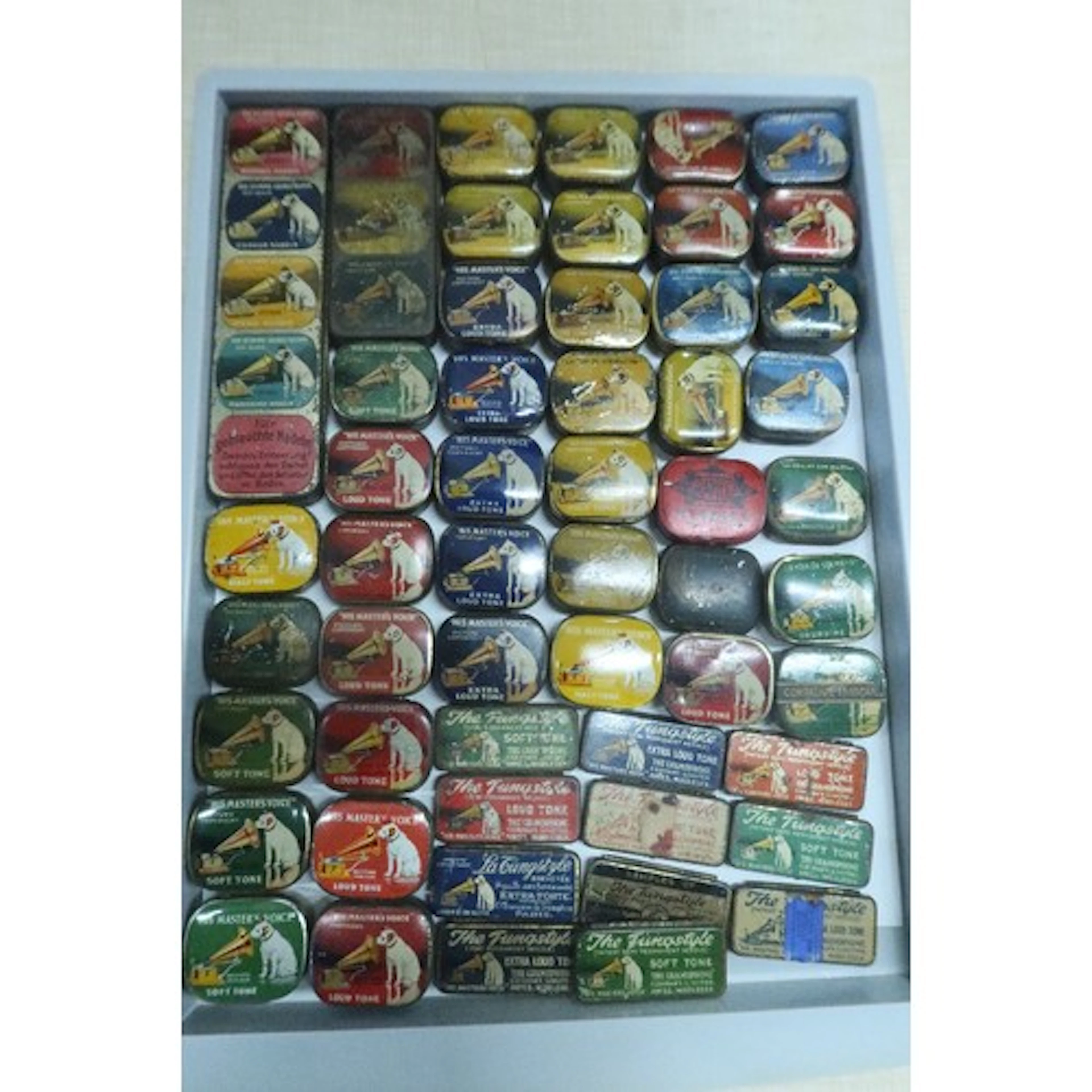 A tray of vintage gramphone needle tins