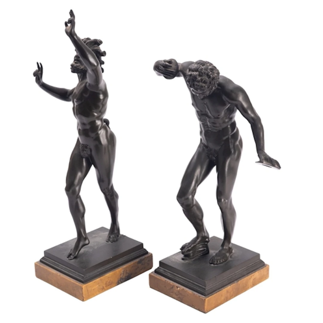 A pair of Continental patinated bronze models of fauns, cast...