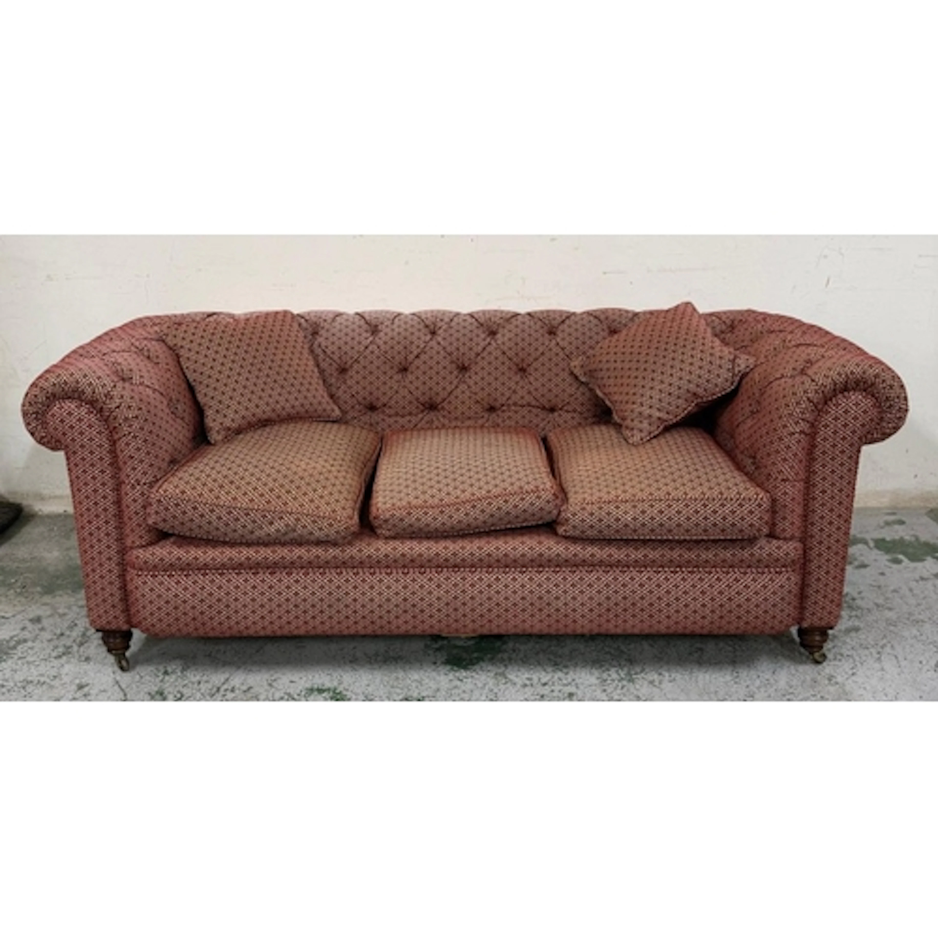 A red and white upholstered Chesterfield style three seater ...