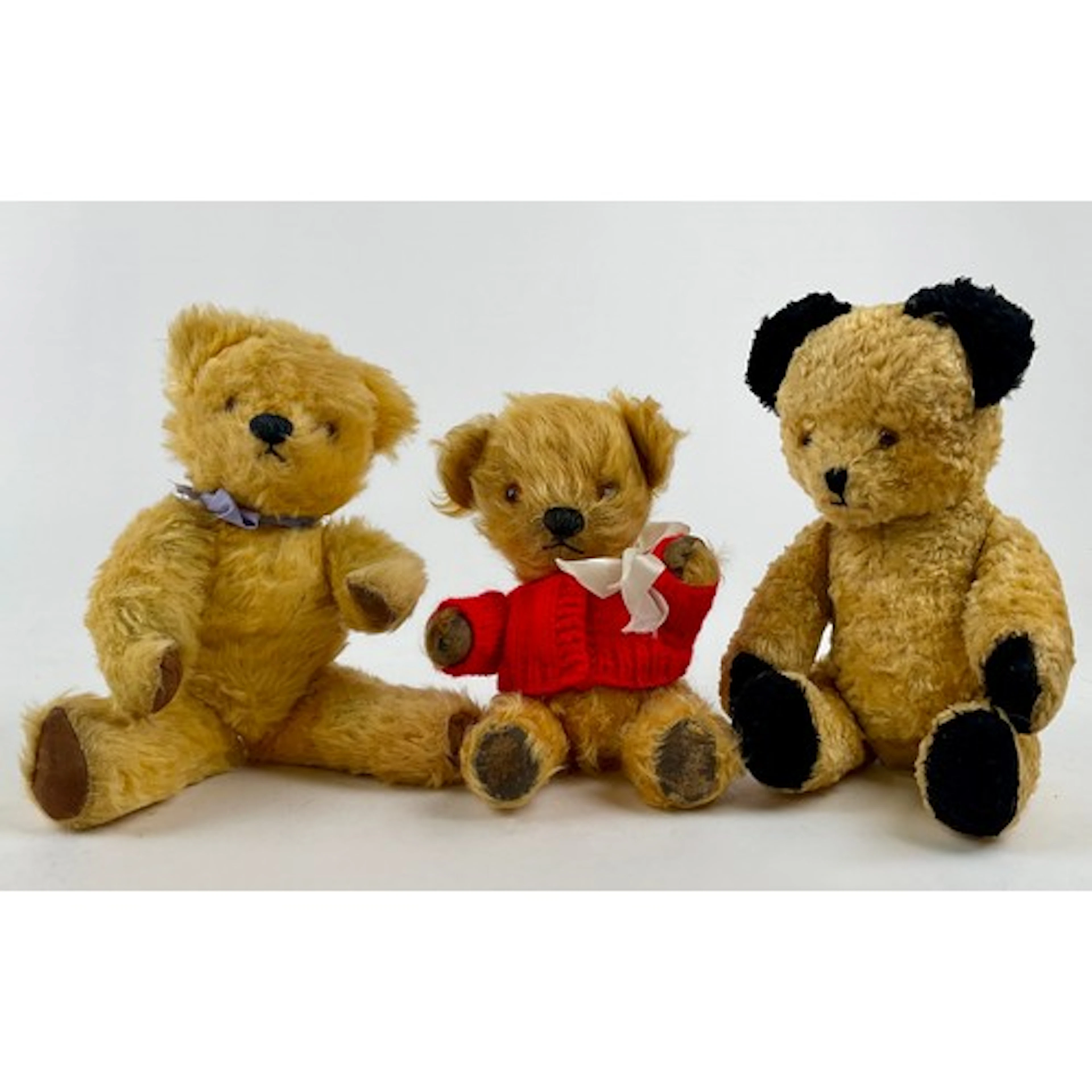 A 1950’s Sooty type silk Teddy bear, black ears and paws, a,...