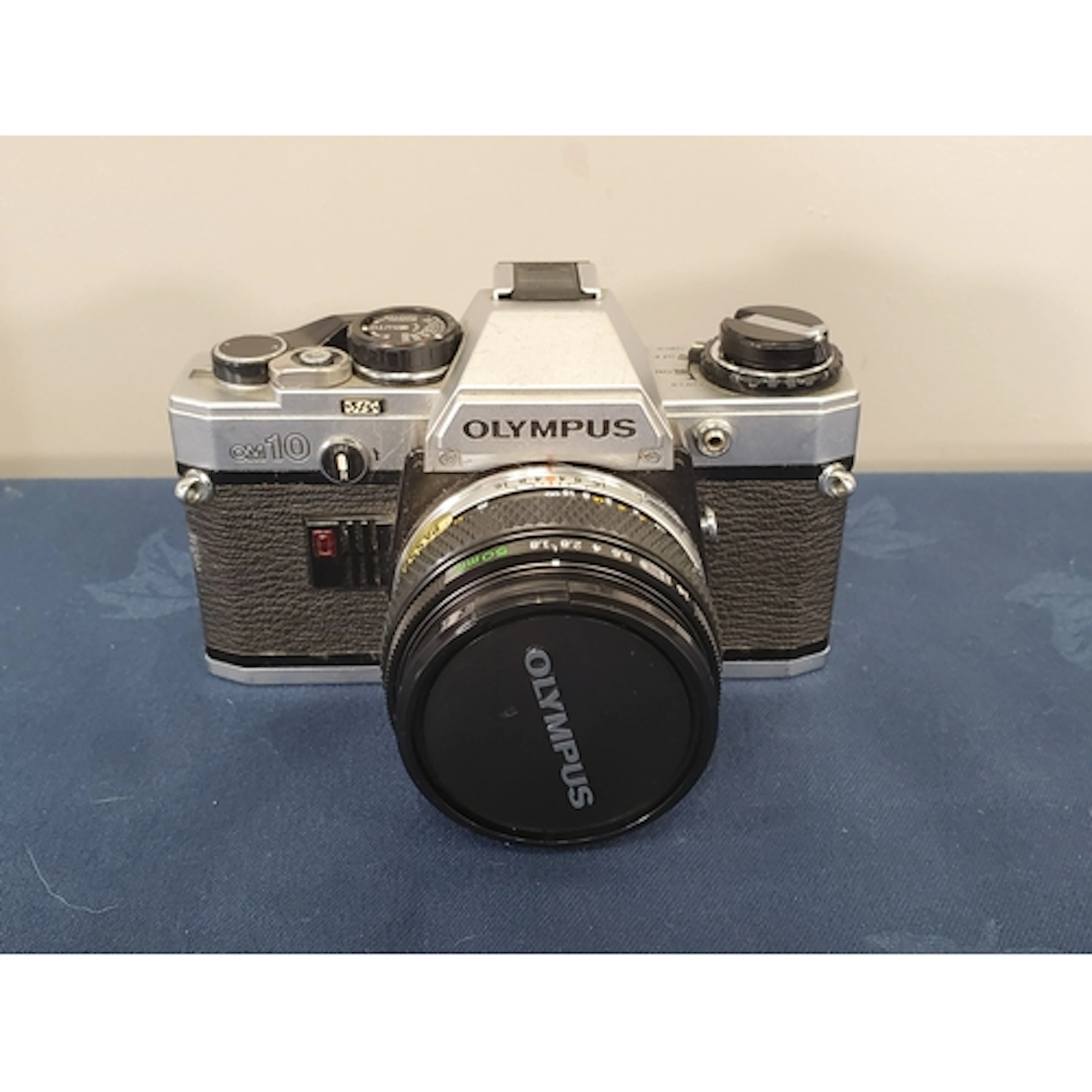 An Olympus OM-10 silver with 50mm f1.8 Zuiko
