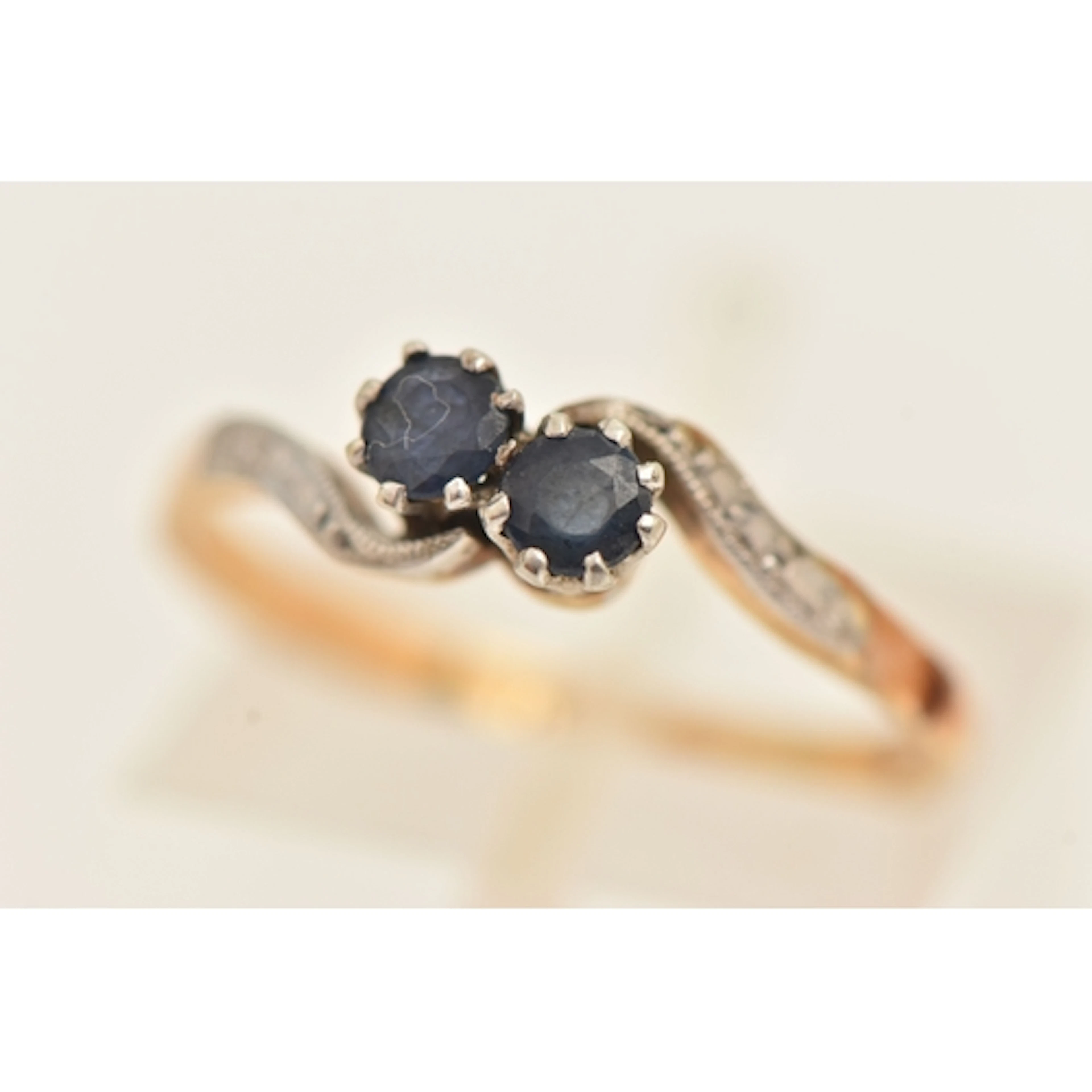 A YELLOW METAL AND SAPPHIRE TOI ET MOI RING, stamped 18ct & ...