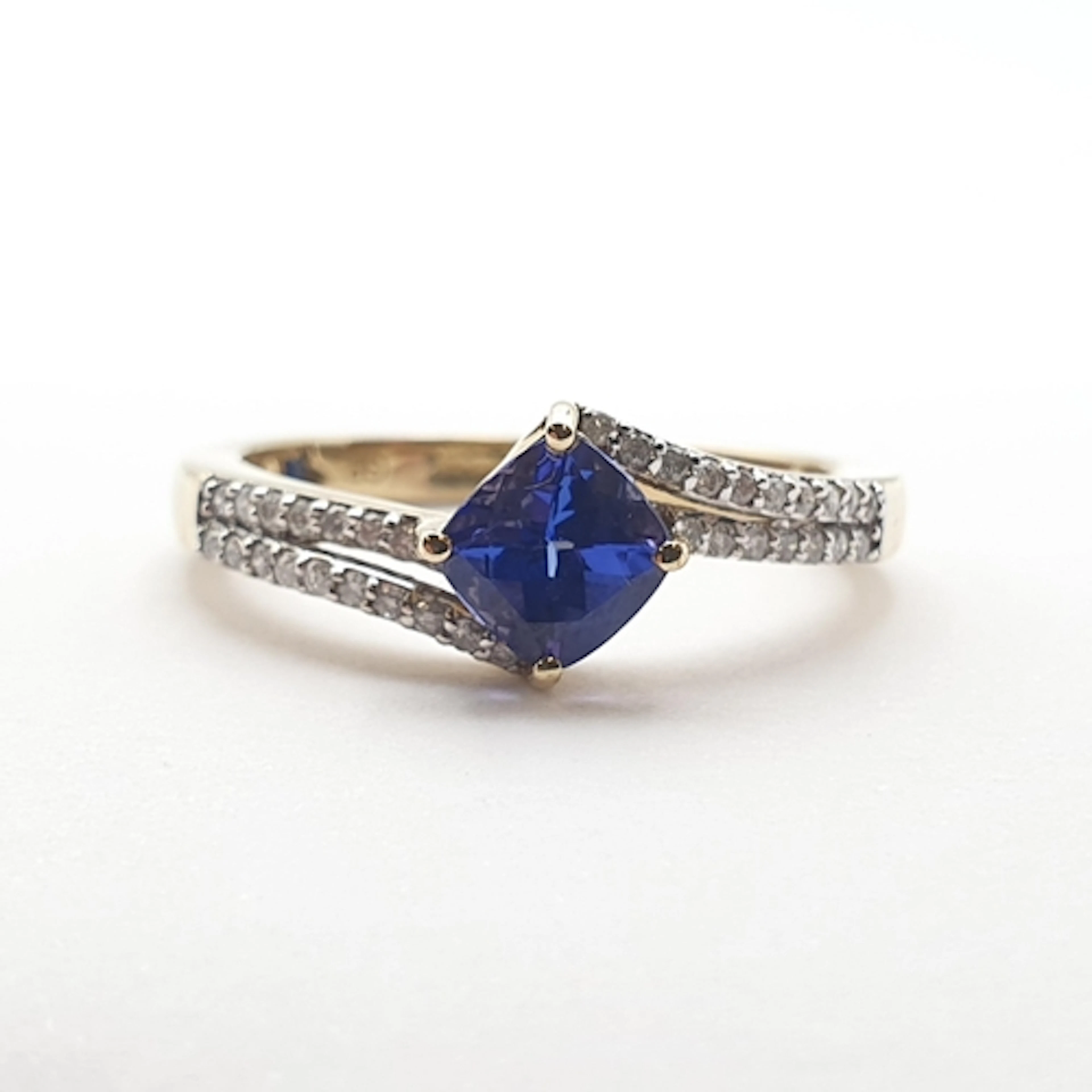A Tanzanite and Diamond Dress Ring, claw-set cushion-cut tan...