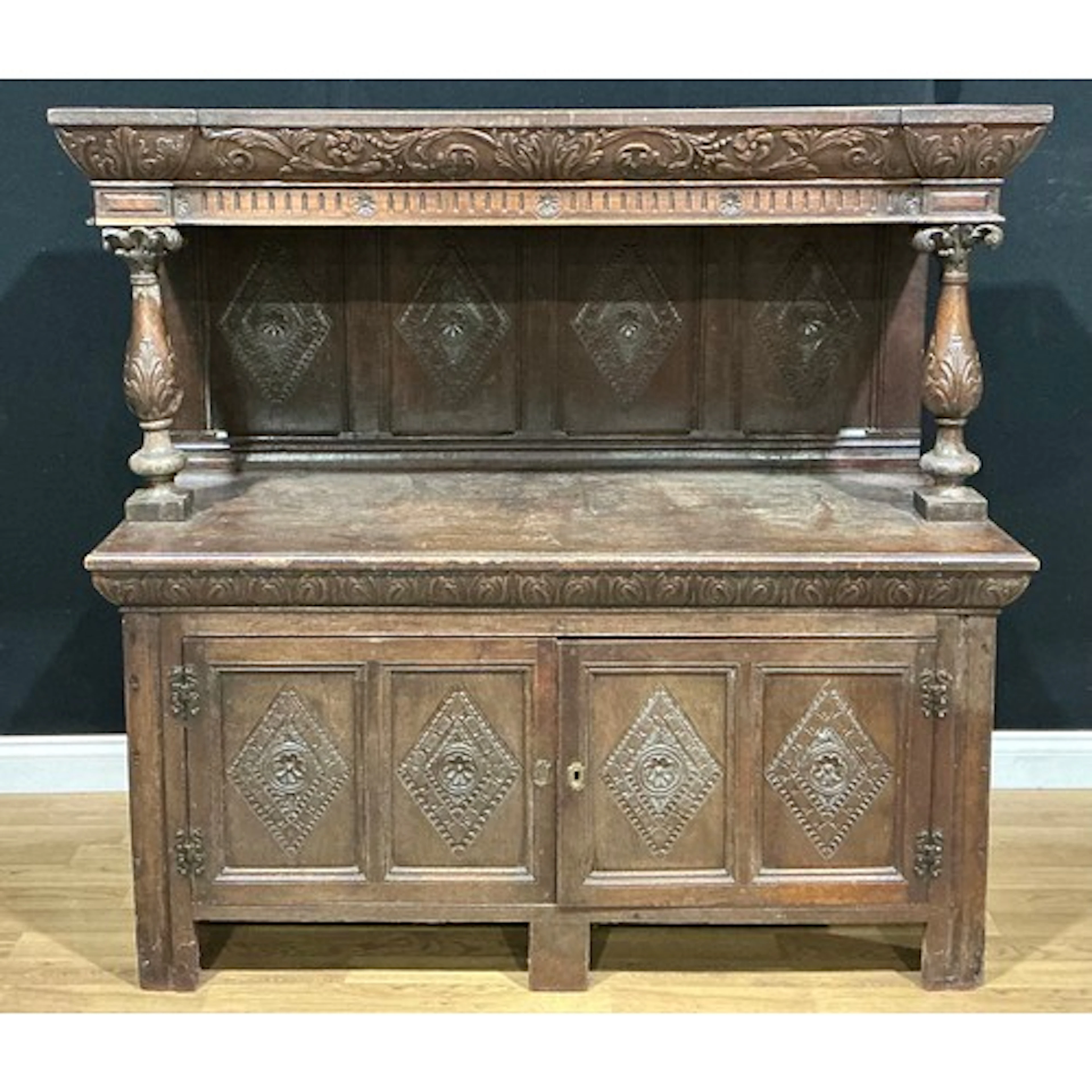 A late Victorian Carolean Revival oak livery cupboard, carve...