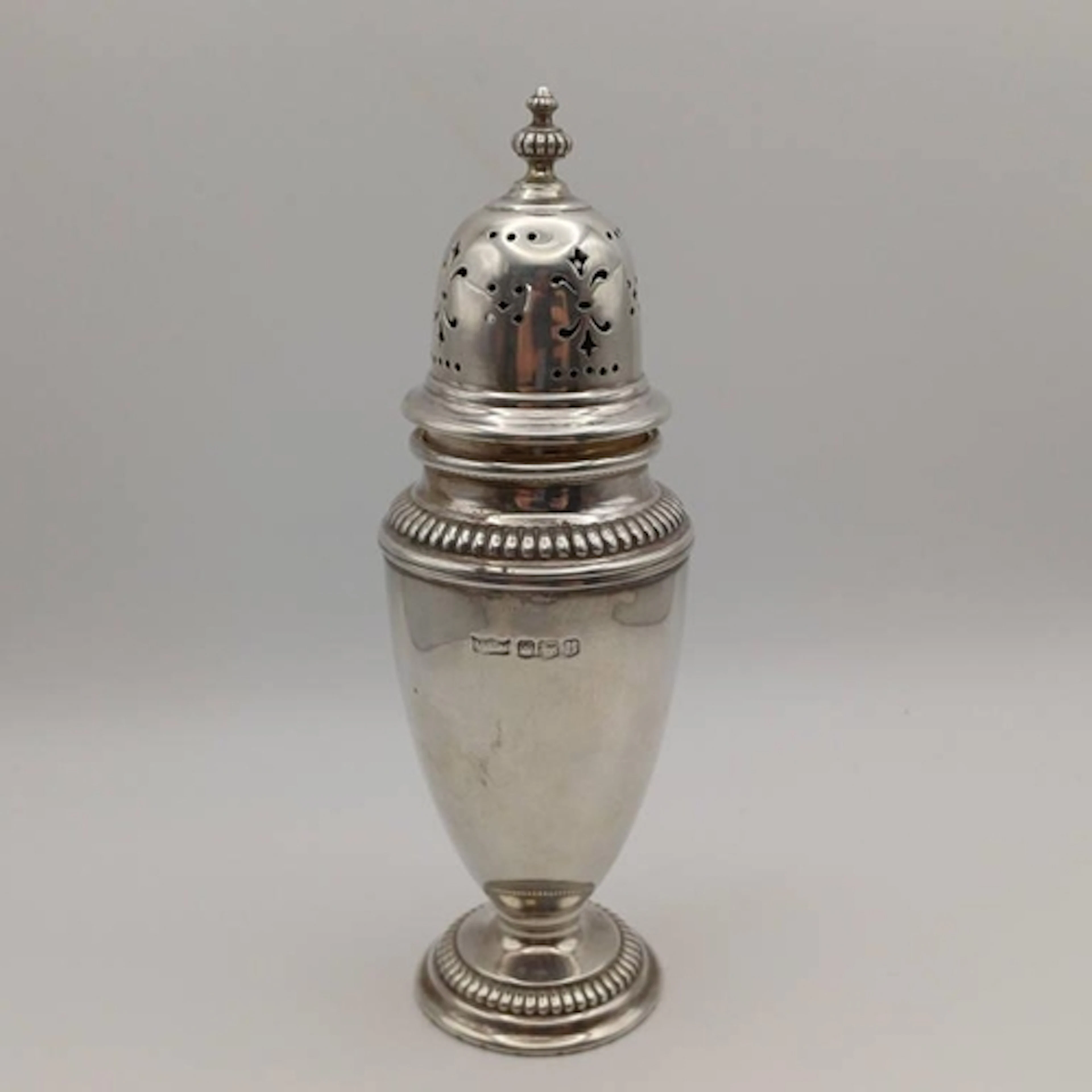 A SILVER SUGAR CASTOR BY MAPPIN & WEBB LTD, SHEFFIELD 1962. ...